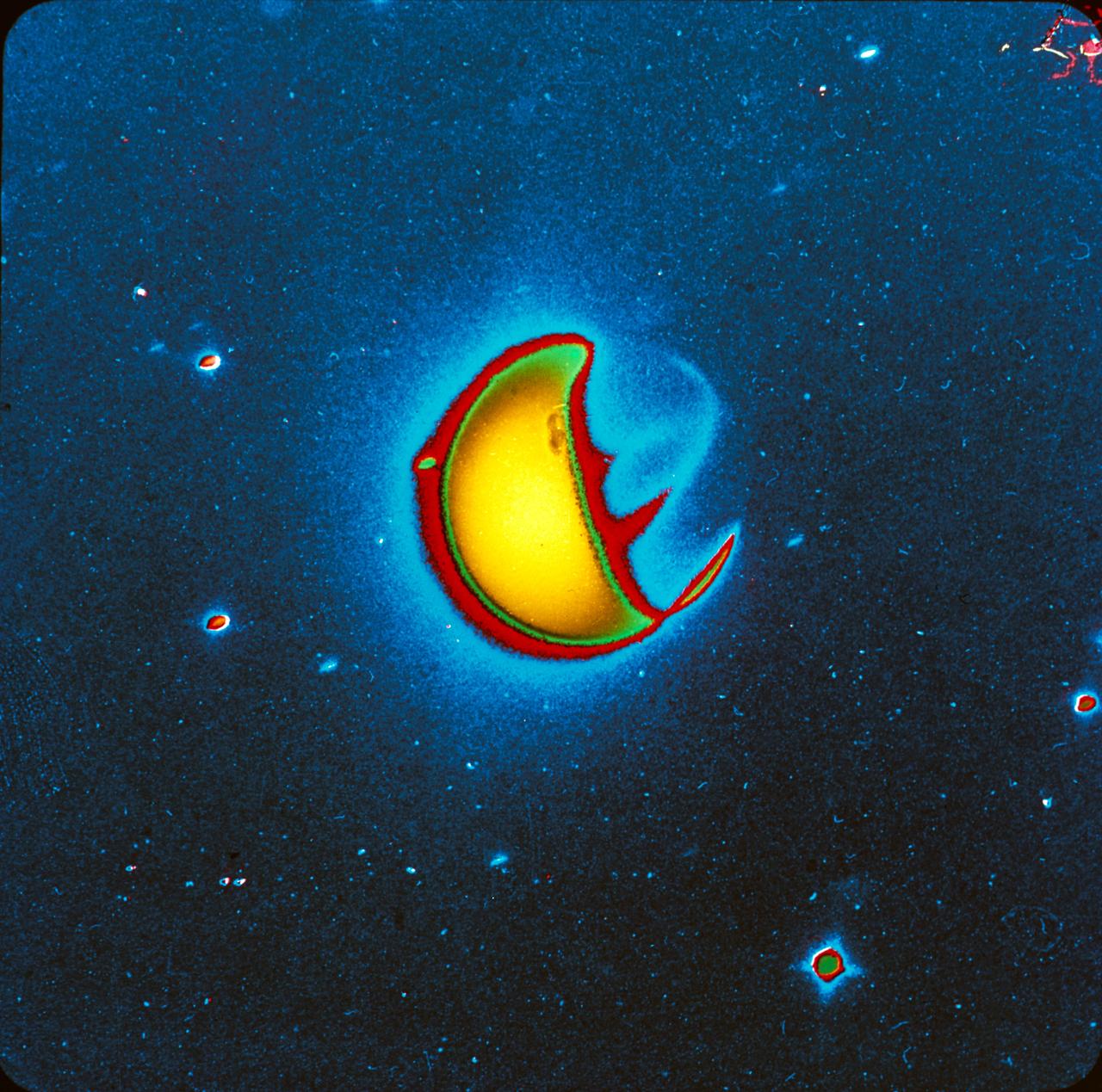 S72-40821 (21 April 1972) --- An artificially reproduced color enhancement of a ten-minute far-ultraviolet exposure of Earth, taken with a filter which blocks the glow caused by atomic hydrogen but which transmits the glow caused by atomic oxygen and molecular nitrogen. Note that airglow emission bands are visible on the night side of Earth, one roughly centered between the two polar auroral zones and one at an angle to this extending northward toward the sunlit side of Earth. The UV camera was operated by astronaut John W. Young on the Apollo 16 lunar landing mission. It was designed and built at the Naval Research Laboratory, Washington, D.C.  EDITOR'S NOTE: The photographic number of the original black & white UV camera photograph, from which this artificially reproduced version was made, is AS16-123-19657.