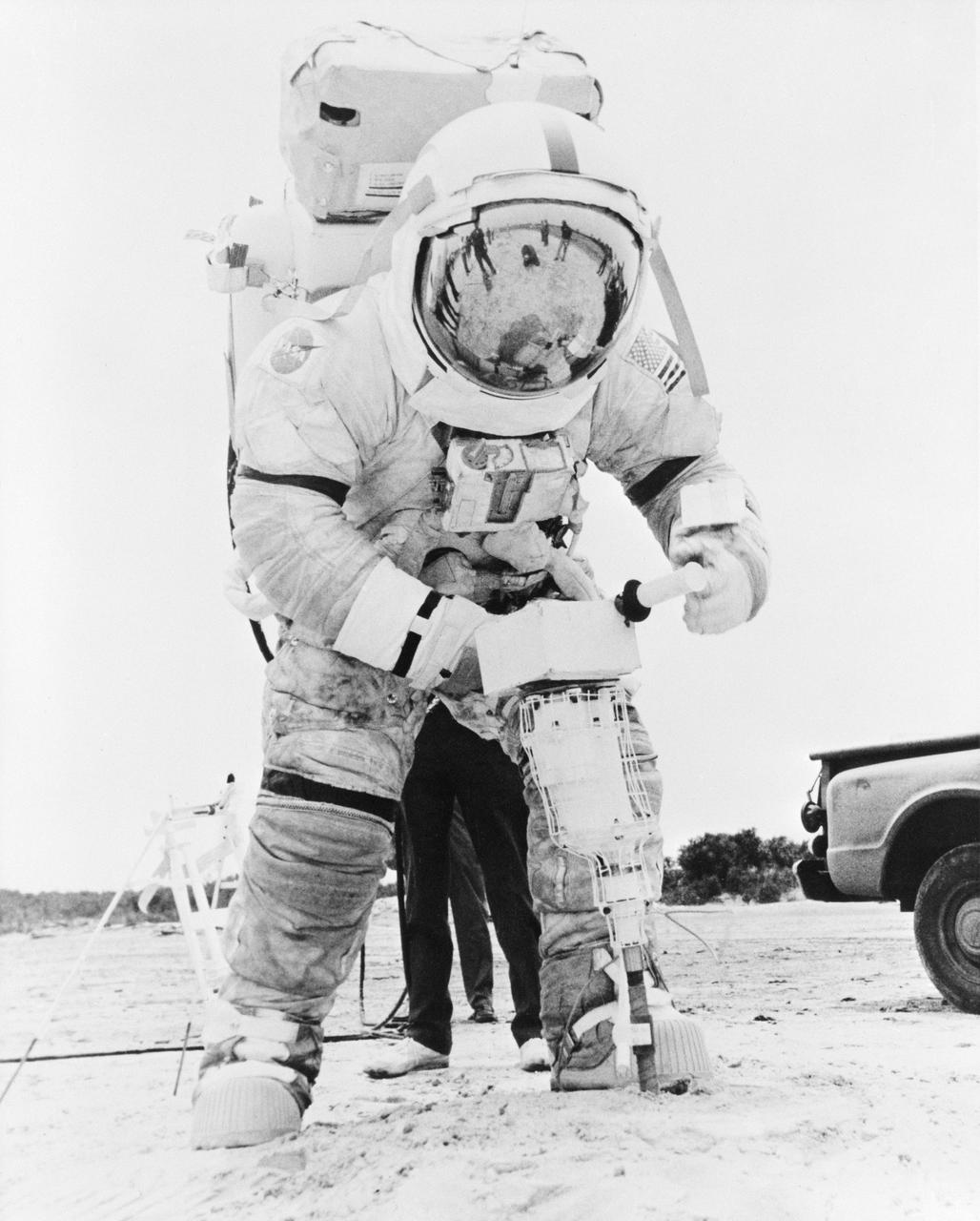 S72-44421 (June 1972) --- Astronaut Eugene A. Cernan, commander of the Apollo 17 lunar landing mission, practices with a lunar drill during lunar surface EVA simulations.