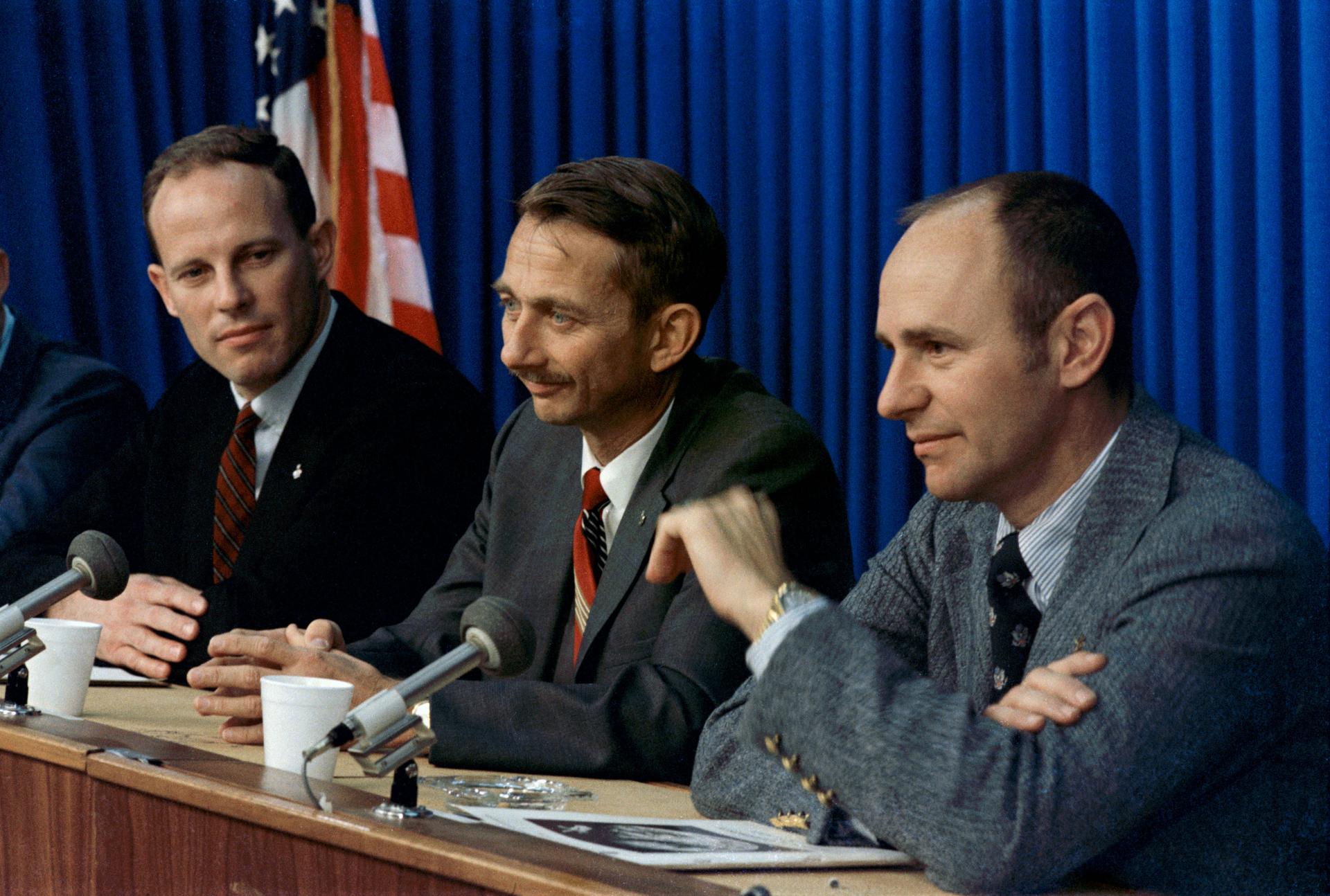 Jack Lousma, Owen Garriott, and Al Bean answer questions at a press conference