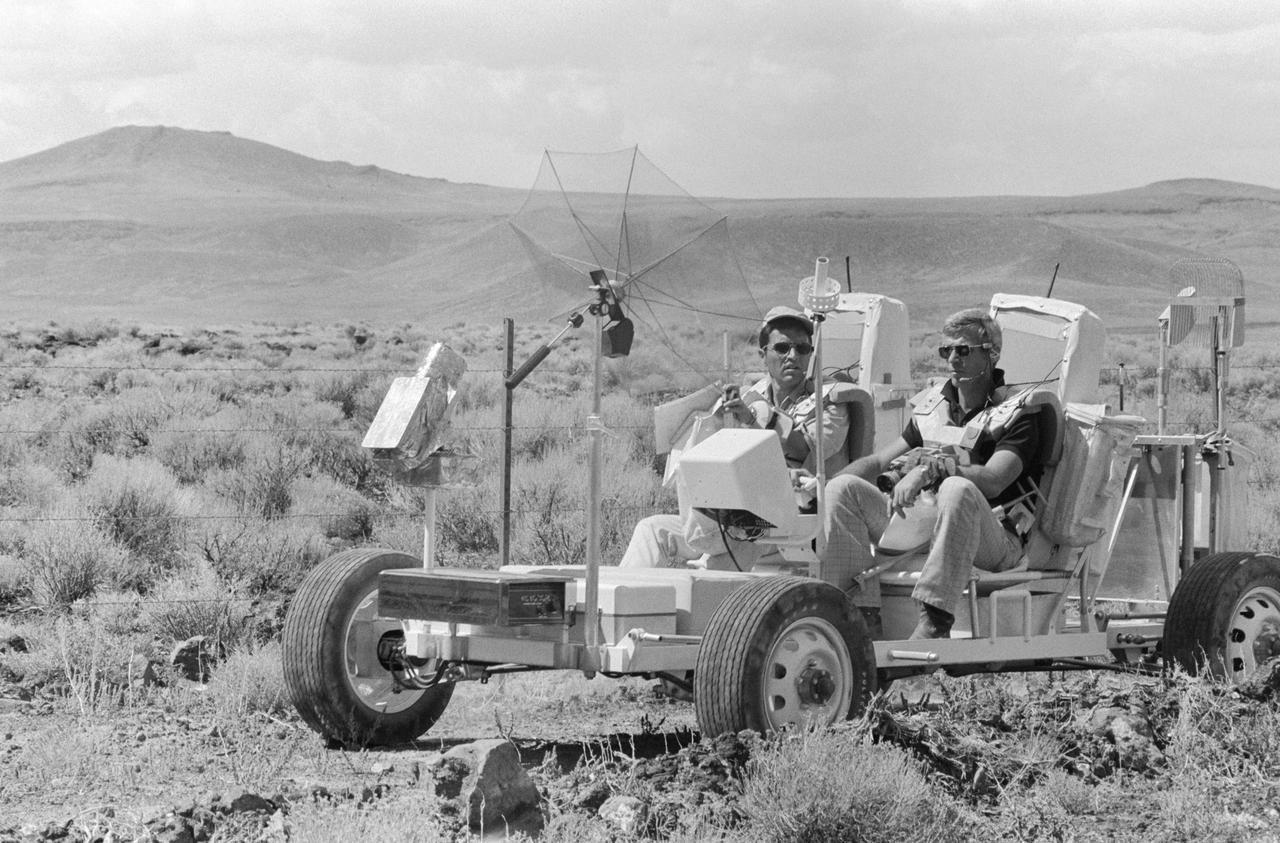 S72-48864 (6 Sept. 1972) --- Two members of the prime crew of the Apollo 17 lunar landing mission ride in a Lunar Roving Vehicle trainer during lunar surface extravehicular activity simulation training in the Pancake Range area of south-central Nevada. They are astronaut Eugene A. Cernan (foreground), commander; and scientist-astronaut Harrison H. Schmitt (on Cernan’s right), lunar module pilot.