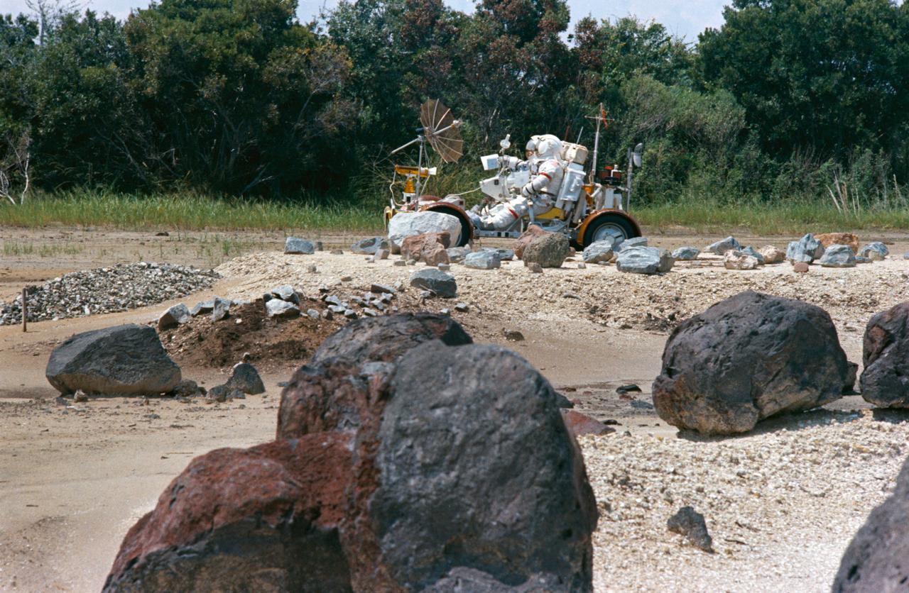 S72-48889 (September 1972) --- Two members of the prime crew of the Apollo 17 lunar landing mission ride in a lunar roving vehicle trainer during lunar surface extravehicular activity simulation training at the Kennedy Space Center, Florida. Astronaut Eugene A. Cernan, commander, is seated in the left-hand seat. Scientist-astronaut Harrison H. Schmitt, lunar module pilot, is on Cernan's right.