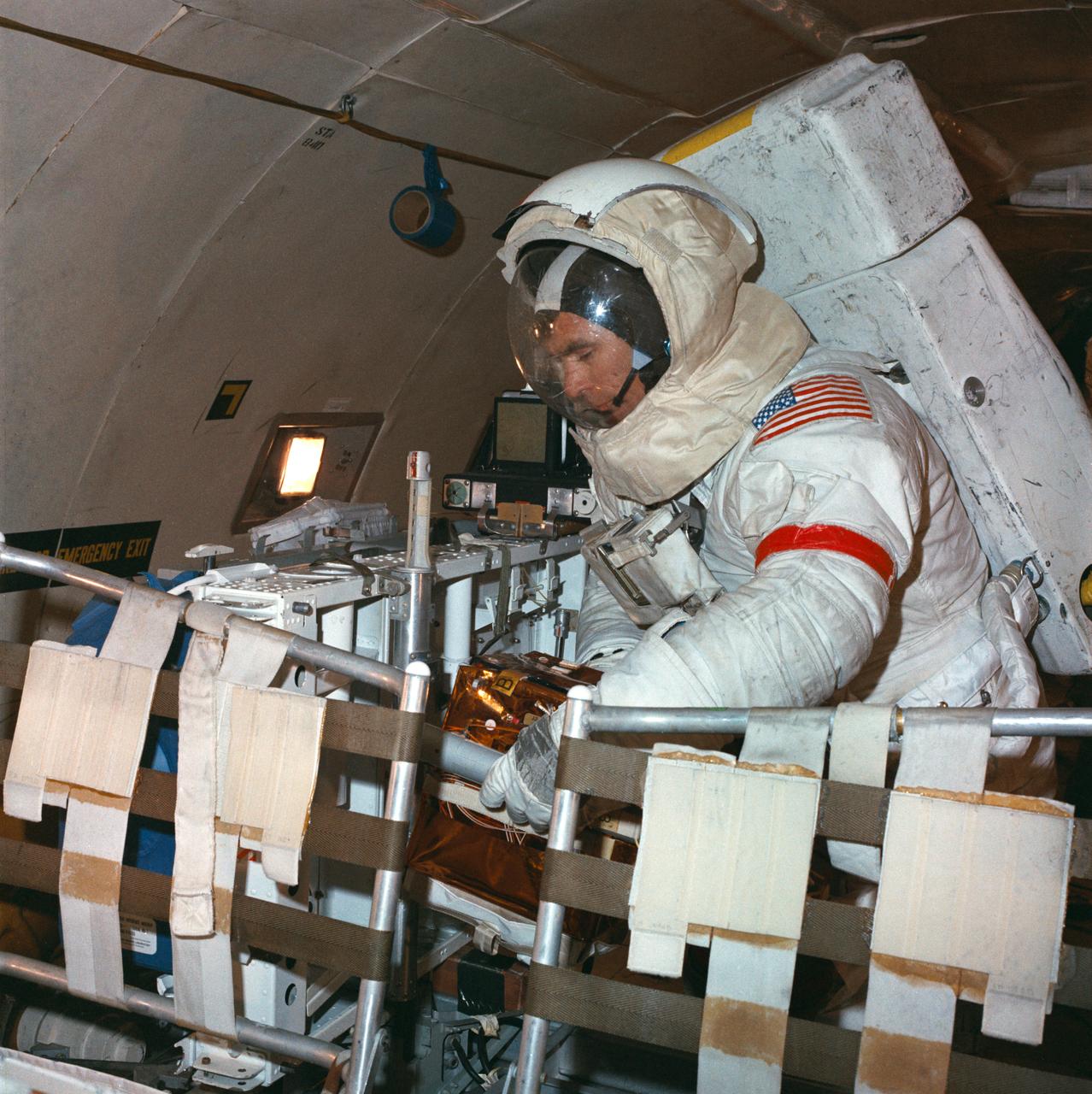S72-50270 (September 1972) --- Astronaut Eugene A. Cernan, commander of the Apollo 17 lunar landing mission, participates in lunar surface extravehicular activity simulation training under one-sixth gravity conditions aboard a U. S. Air Force KC-135 aircraft. Here, Cernan simulates removing an experiment package from the aft end of a Lunar Roving Vehicle.