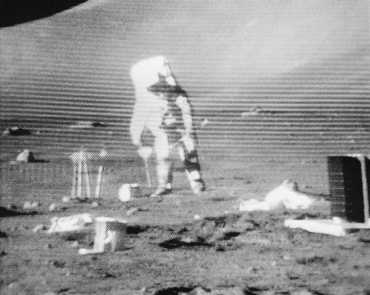 S72-55065 (11 Dec. 1972) --- Scientist-astronaut Harrison H. Schmitt is seen anchoring the geophone module with a flag during the first Apollo 17 extravehicular activity (EVA) at the Taurus-Littrow landing site, in the black and white reproduction taken from a color television transmission made by the color RCA TV camera mounted on the Lunar Roving Vehicle. Schmitt is the lunar module mounted on the Lunar Roving Vehicle. Schmitt is the lunar module pilot of the Apollo 17 lunar landing mission. Astronaut Ronald E. Evans, command module pilot, remained with the Apollo 17 Command and Service Modules in lunar orbit while astronauts Schmitt and Eugene A. Cernan, commander, descended in the Lunar Module to explore the moon. The geophone module is part of the Lunar Seismic Profiling Experiment (S-203), a component of the Apollo Lunar Surface Experiments Package (ALSEP). Other ALSEP components are visible in the picture.