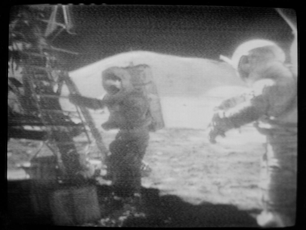 S72-55299 (13 Dec. 1972) --- Scientist-astronaut Harrison H. Schmitt, Apollo 17 lunar module pilot, starts back up the ladder of the Lunar Module "Challenger" at the close of the third extravehicular activity (EVA) at the Taurus-Littrow landing site, in this black and white reproduction taken from a color television transmission made by the color RCA TV camera mounted on the Lunar Roving Vehicle. On the right is astronaut Eugene A. Cernan, commander, who ingressed the LM a few minutes later. Astronaut Ronald E. Evans, command module pilot, remained with the Apollo 17 Command and Service Modules in lunar orbit.