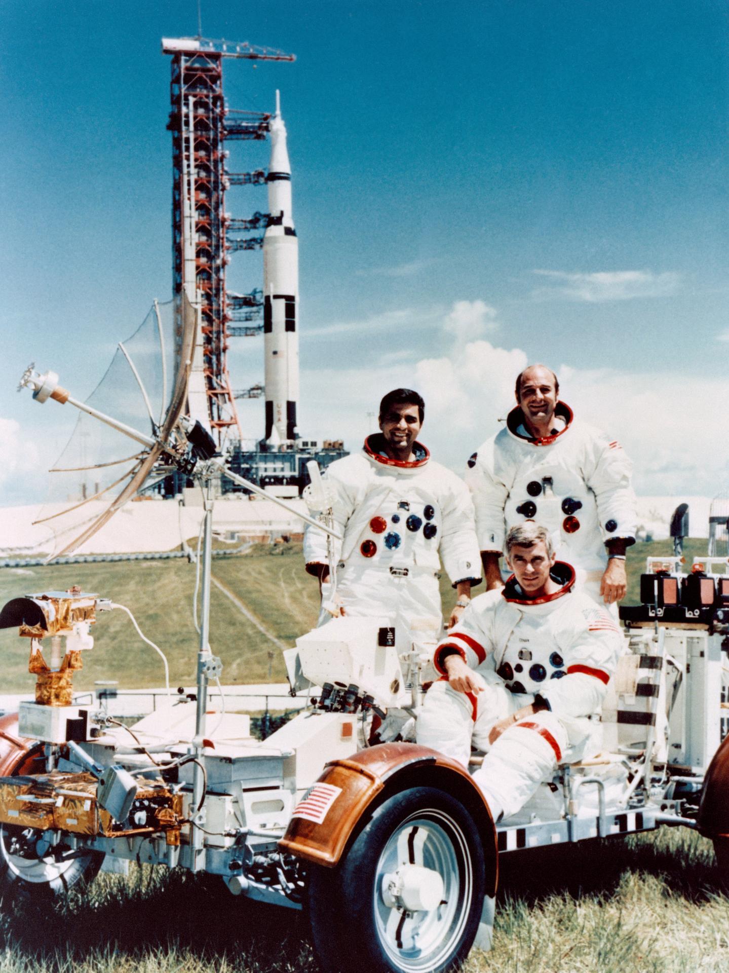 Portrait of the crew of Apollo 17 with a lunar rover at Kennedy Space Center with their Saturn V vehicle