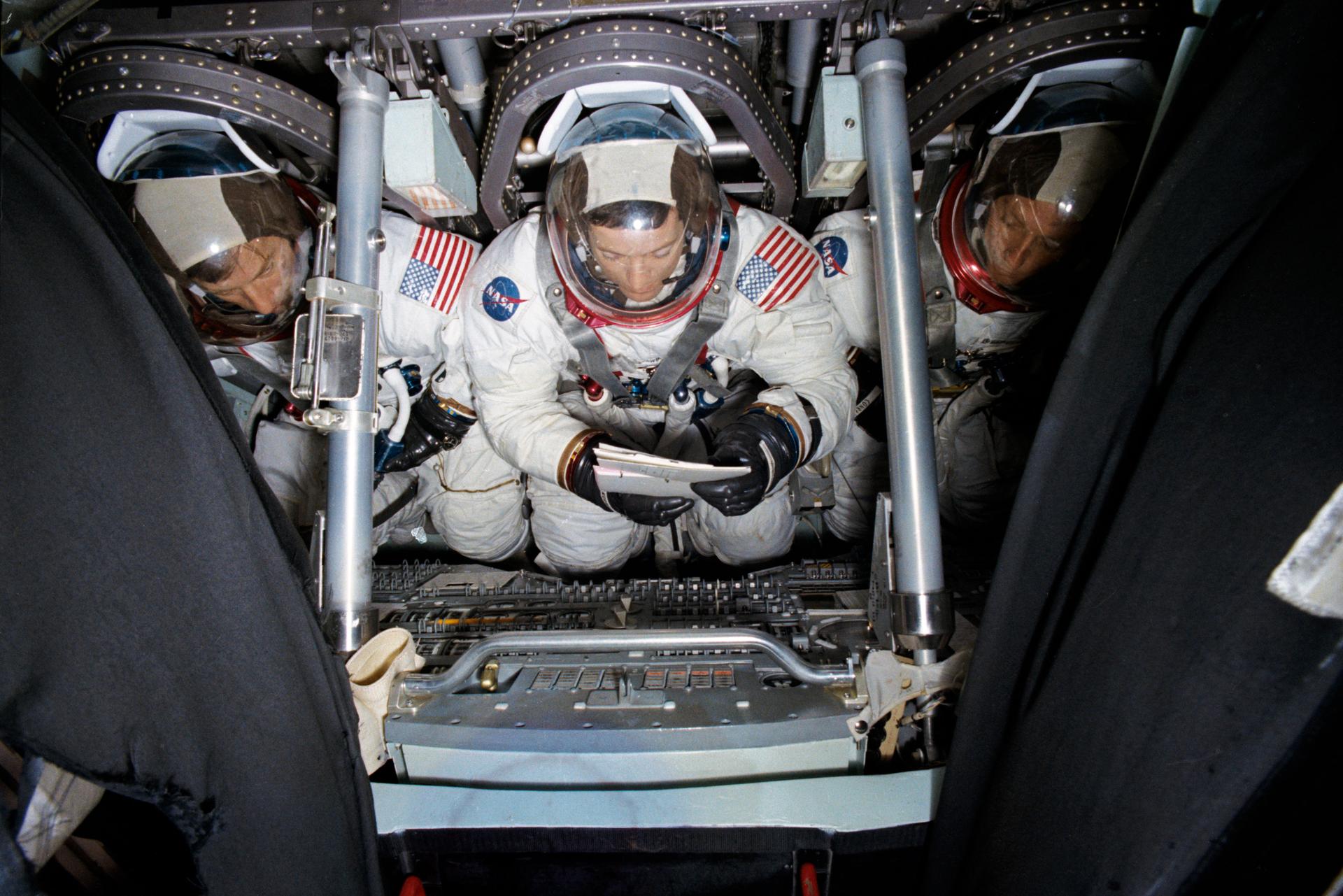 Overhead view of the Skylab 2 prime crew inside the Apollo Command Module Mission Simulator