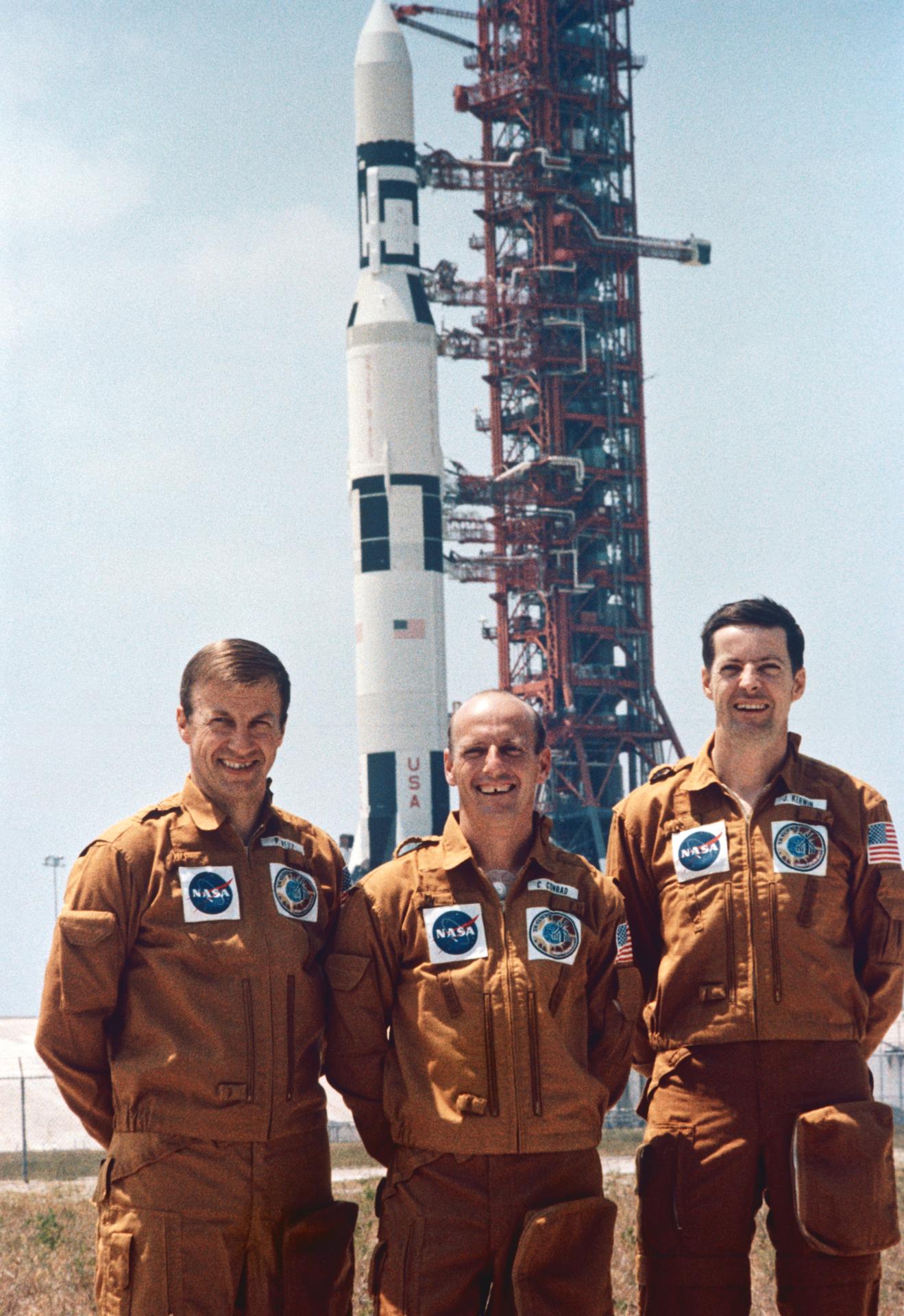 Skylab 2 prime crew poses in front of the Skylab/Saturn V rocket at Kennedy Space Center