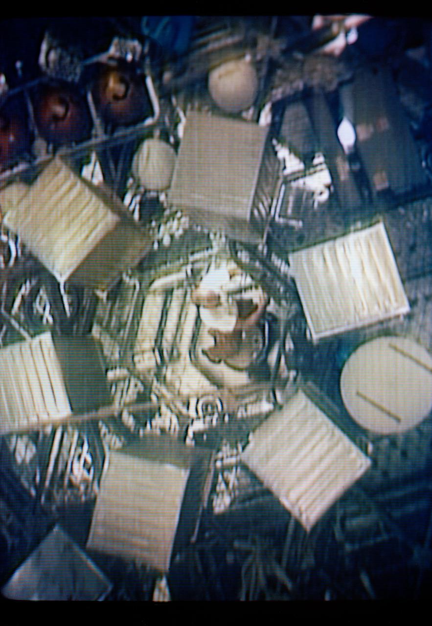S73-26776 (26 May 1973) --- An interior view of the Orbital Workshop of the Skylab 1 space station cluster in Earth orbit can be seen in this reproduction taken from a color television transmission made by a TV camera aboard the space station. Astronaut Charles Conrad Jr., Skylab 2 commander, is floating up through the hatch. Food lockers are in the foreground. Photo credit: NASA