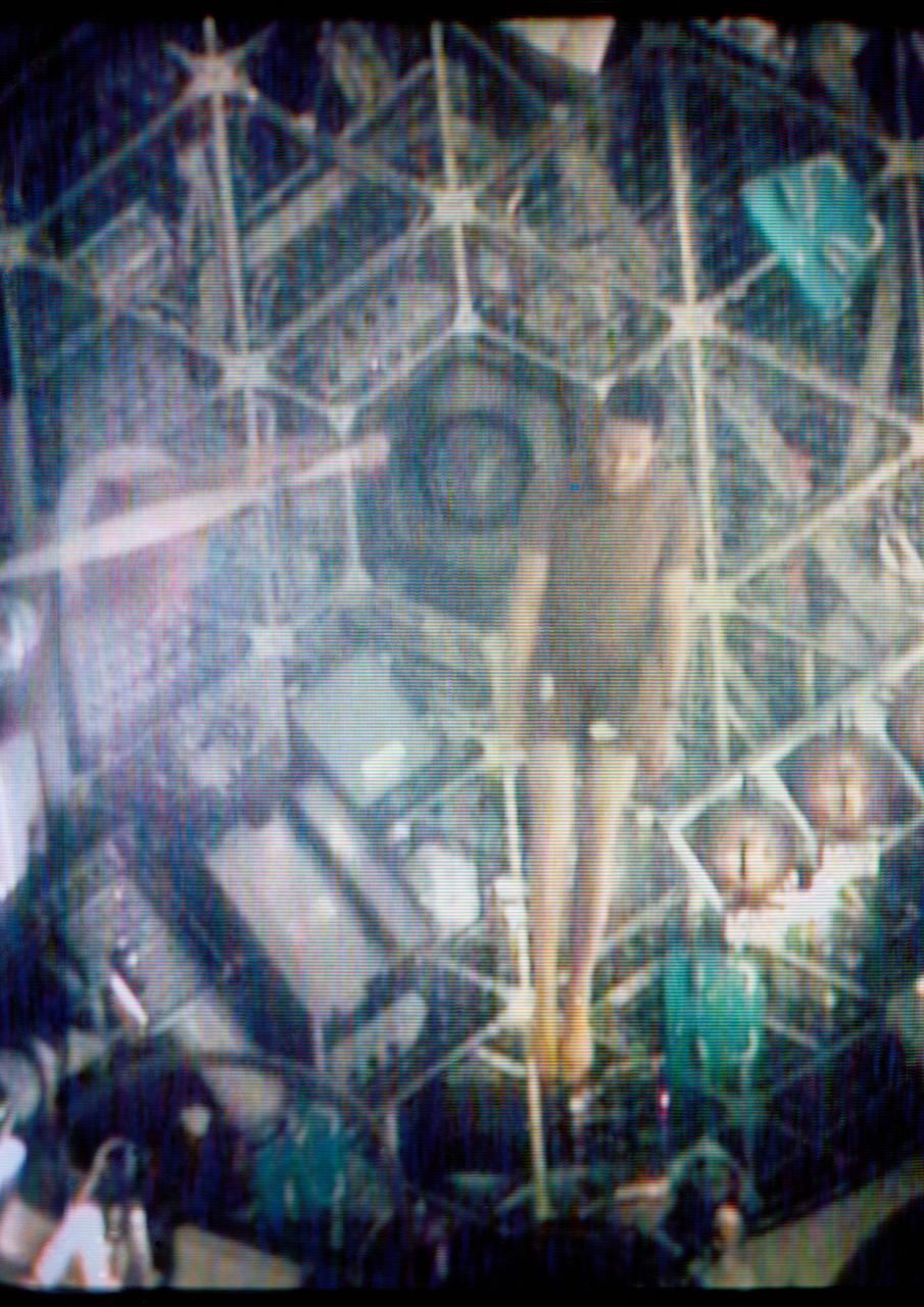 S73-27260 (1 June 1973) --- Two of the three Skylab 2 crewmen demonstrate weightlessness in the forward compartment of the Orbital Workshop of the Skylab 1 & 2 space station cluster in Earth orbit, as seen in this reproduction taken from a color television transmission made by a TV camera aboard the space station. Scientist-astronaut Joseph P. Kerwin, science pilot, floats with his body extended. Kerwin is steadied by astronaut Charles Conrad Jr., commander. The crewmen performed exercises while floating. Photo credit: NASA