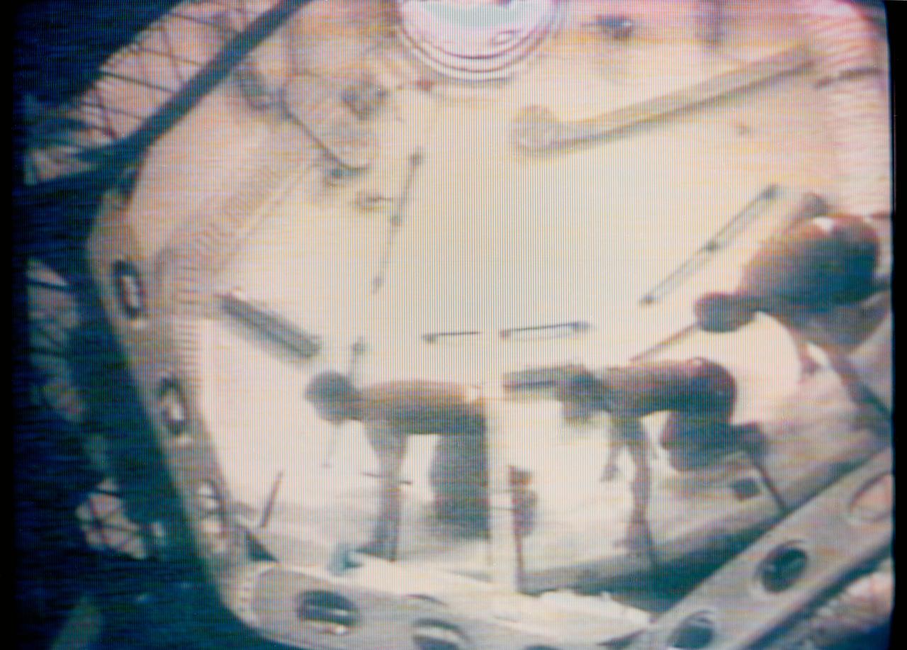 S73-27262 (1 June 1973) --- The three Skylab 2 crewmen give a demonstration on the effects of weightlessness in the Orbital Workshop of the Skylab 1 and 2 space station cluster in Earth orbit, as seen in this reproduction taken from a color television transmission made by a TV camera aboard the space station. Astronauts Charles Conrad Jr., Joseph P. Kerwin and Paul J. Weitz are crouched in a fast-start stance to race around the dome area of the OWS forward compartment. The astronauts had ease of motion and good maneuverability in the zero-gravity of space. Photo credit: NASA