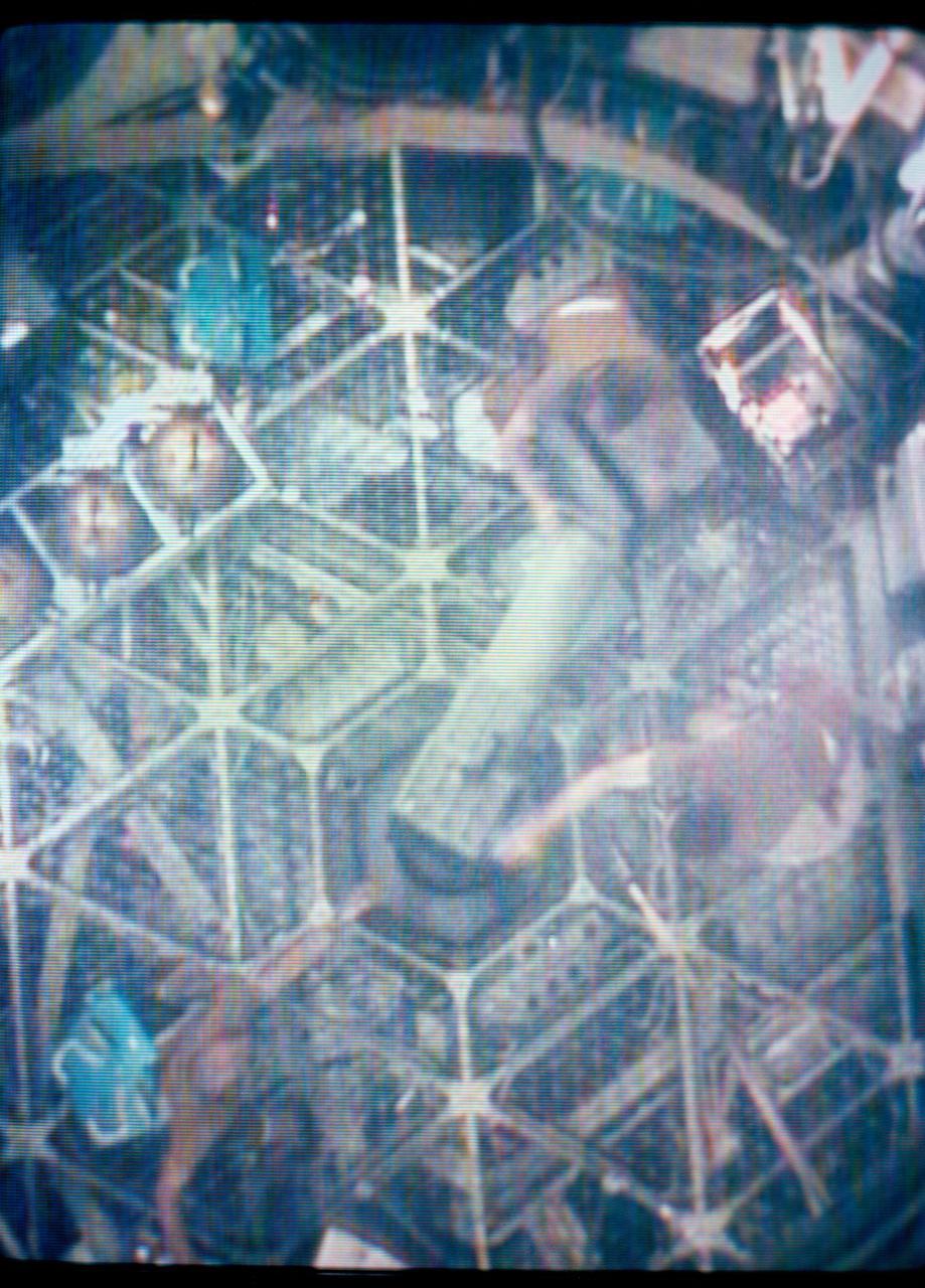 S73-27730 (June 1973) --- The Skylab 2 crewmen, astronauts Charles Conrad Jr., Joseph P. Kerwin and Paul J. Weitz, move the S183 Ultraviolet Panorama astrophysics experiment equipment under zero-gravity conditions in space in the foreground compartment of the Orbital Workshop of the Skylab 1 & 2 space station in Earth orbit, as seen in this reproduction taken from a color television transmission made by a TV camera aboard the space station. The S183 equipment includes the S183 spectrograph, the S019 mirror assembly, and a Maurer camera. Photo credit: NASA