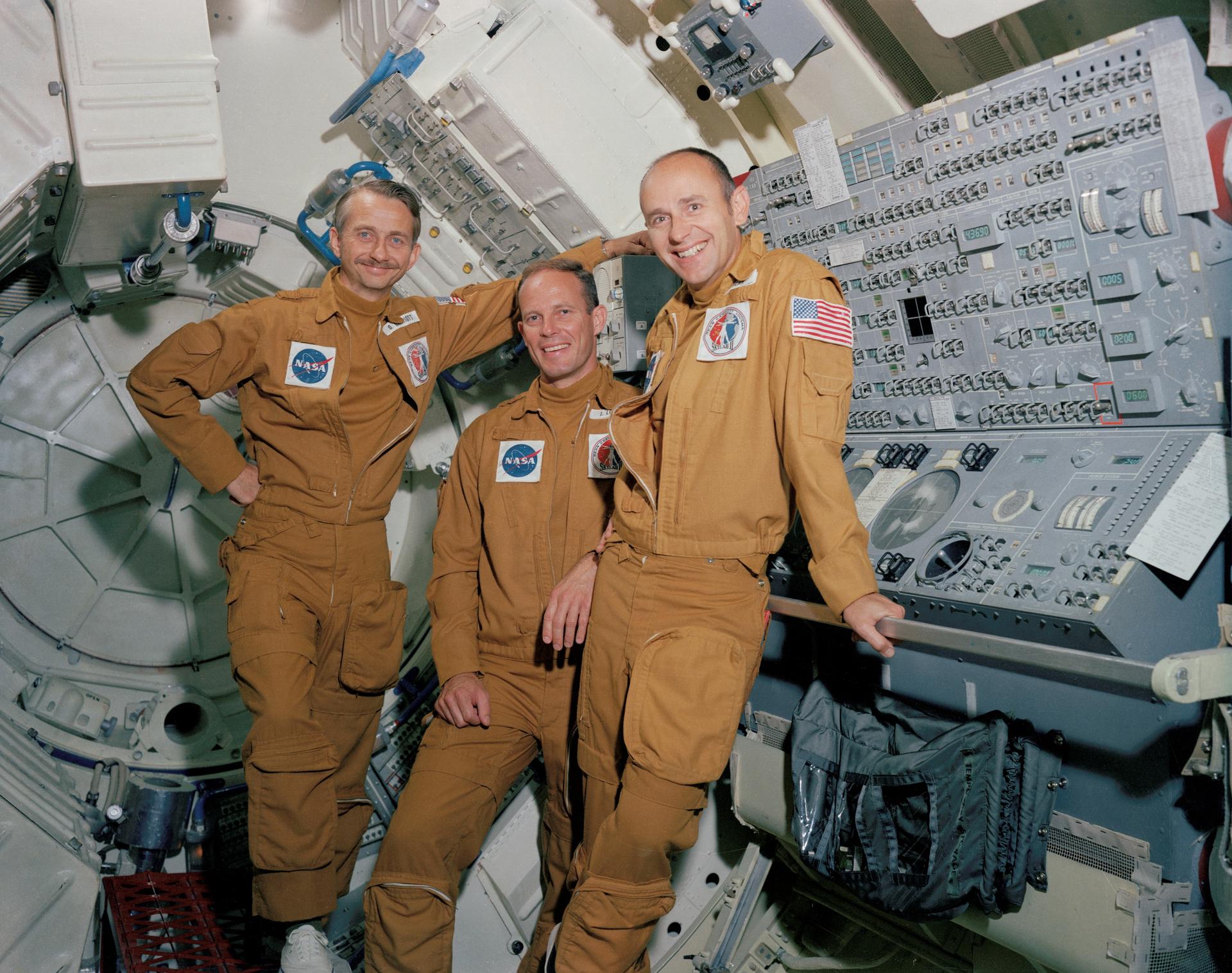 Owen Garriott, Jack Lousma, and Al Bean pose for a photo in the Skylab trainer at Johnson Space Center