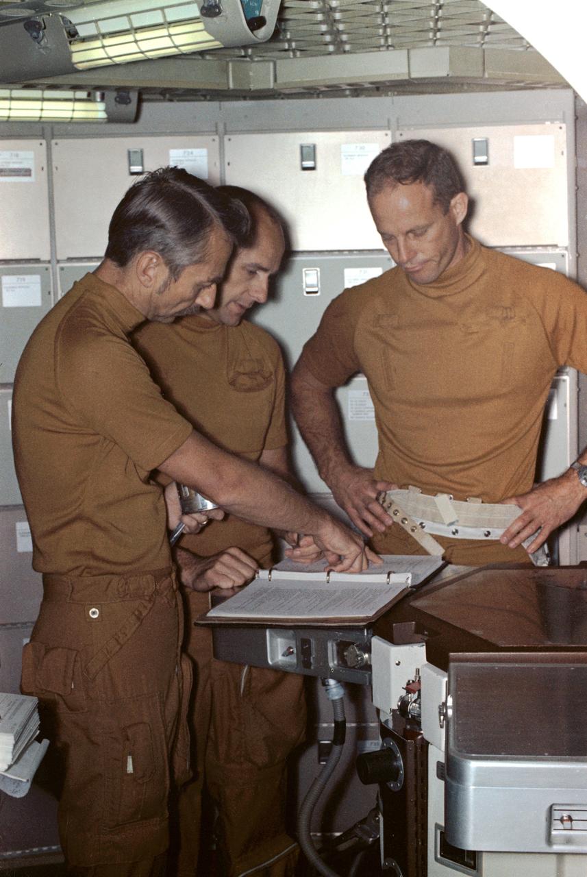 S73-28793 (16 July 1973) --- The three crewmen of the second manned Skylab mission (Skylab 3) go over a checklist during preflight training at the Johnson Space Center. They are, left to right, scientist-astronaut Owen K. Garriott, science pilot; astronaut Alan L. Bean, commander; and astronaut Jack R. Lousma, pilot. They are in the crew quarters of the Orbital Workshop trainer in the Mission Training and Simulation Facility, Building 5, at JSC. Skylab 3 is scheduled as a 59-day mission in Earth orbit. Photo credit: NASA