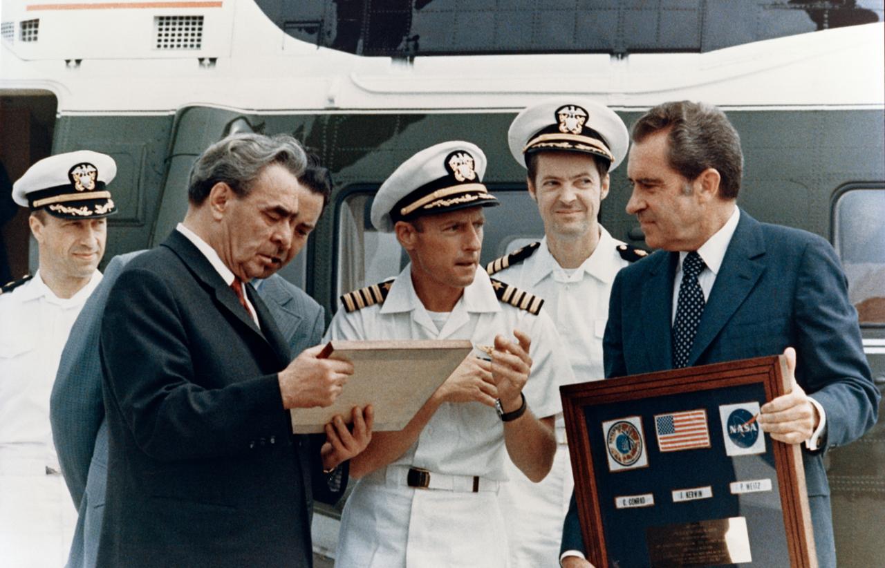 S73-30889 (June 1973) --- Leonid I. Breznev, General Secretary of the Communist Party, Union of Soviet Socialist Republics, and President Richard M. Nixon, during ceremonies at the Western White House in San Clemente, California, examine plaques presented by Skylab astronauts Charles Conrad Jr., center; Joseph P. Kerwin, second from right; and Paul J. Weitz, left. Photo credit: NASA