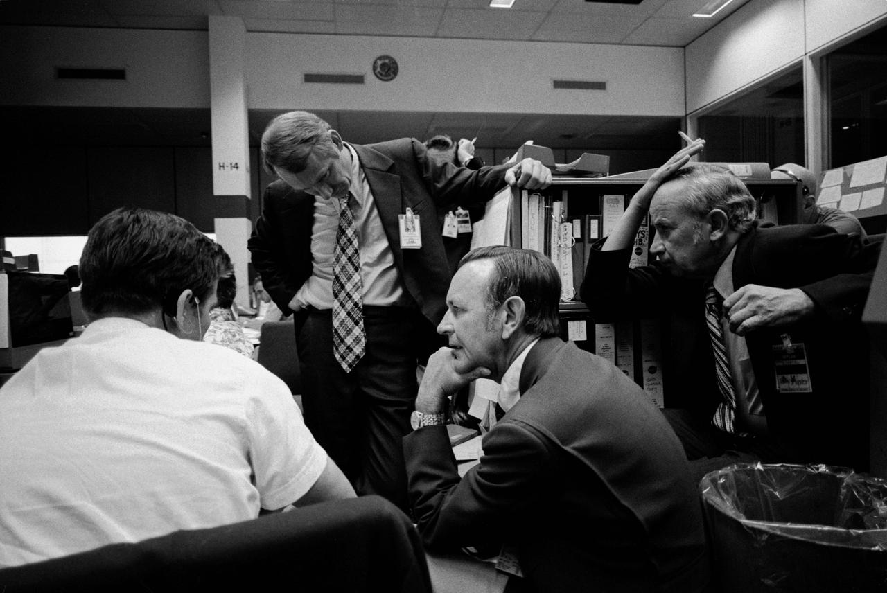 S73-31875 (2 Aug. 1973) --- After learning of a problem in the Command/Service Module which was used to transport the Skylab 3 crew to the orbiting Skylab space station cluster, NASA officials held various meetings to discuss the problem. Here, four men monitor the current status of the problem in the Mission Operations Control Room (MOCR) of the Mission Control Center (MCC) at the Johnson Space Center (JSC). From the left are Gary E. Coen, Guidance and Navigation System flight controller; Howard W. Tindall Jr., Director of Flight Operations at JSC; Dr. Christopher C. Kraft Jr., JSC Director; and Sigurd A. Sjoberg, JSC Deputy Director. Photo credit: NASA