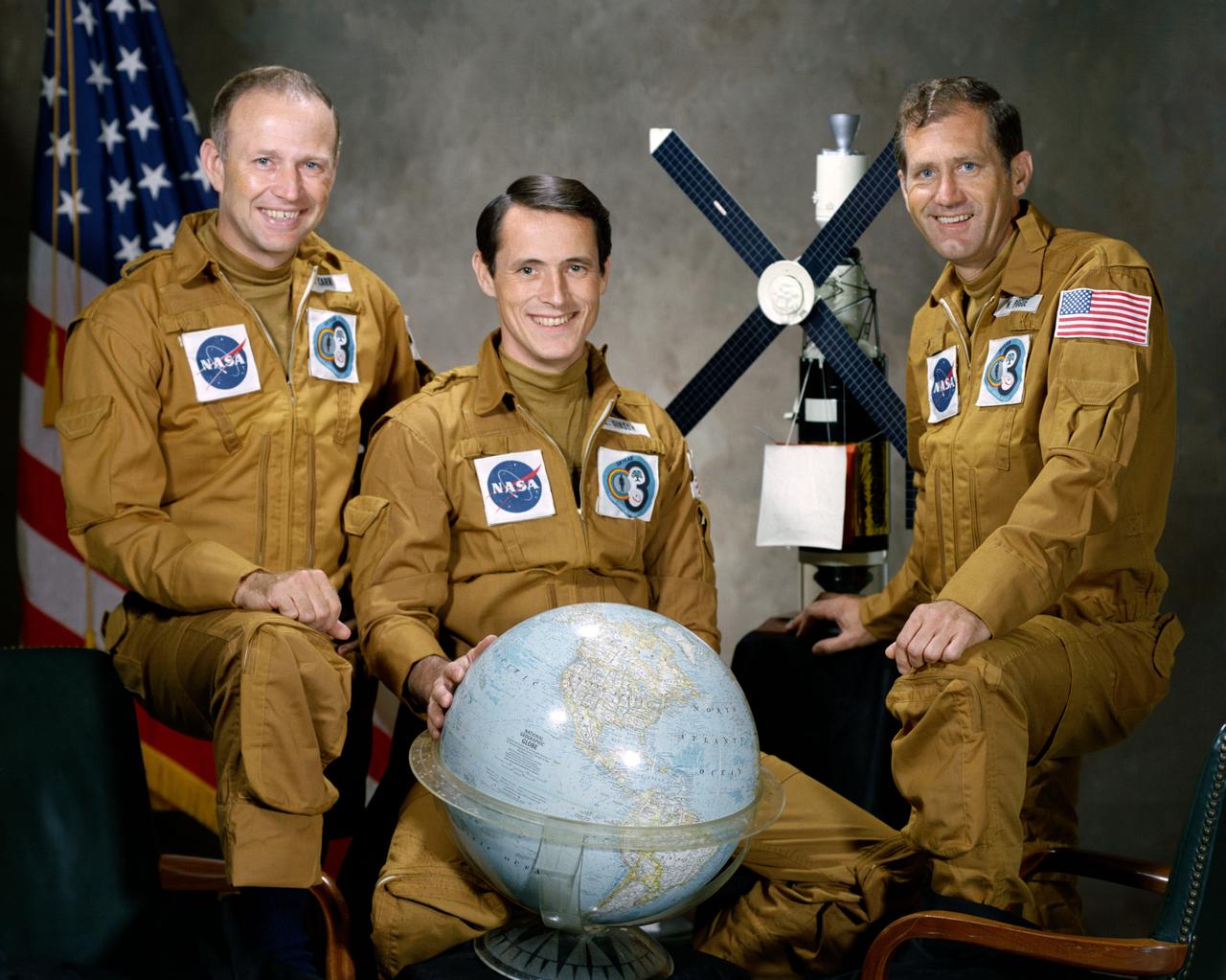 S73-33208 (August 1973) --- These three men are the prime crewmen for the Skylab 4 mission. Pictured in their flight suits with a globe and a model of the Skylab space station are, left to right, astronaut Gerald P. Carr, commander; scientist-astronaut Edward G. Gibson, science pilot; and astronaut William R. Pogue, pilot. Photo credit: NASA