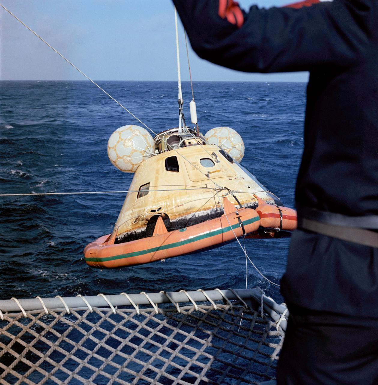 S73-36423 (25 Sept. 1973) --- The Skylab 3 Command Module, with astronauts Alan L. Bean, Owen K. Garriott and Jack R. Lousma still inside, is hoisted aboard the prime recovery ship, USS New Orleans, during recovery operations in the Pacific Ocean. The three crewmen had just completed a successful 59-day visit to the Skylab space station in Earth orbit. The Command Module splashed down in the Pacific about 230 miles southwest of San Diego, California. Earlier in the recovery operations a team of U.S. Navy swimmers attached the flotation collar to the spacecraft to improve its buoyancy. Photo credit: NASA