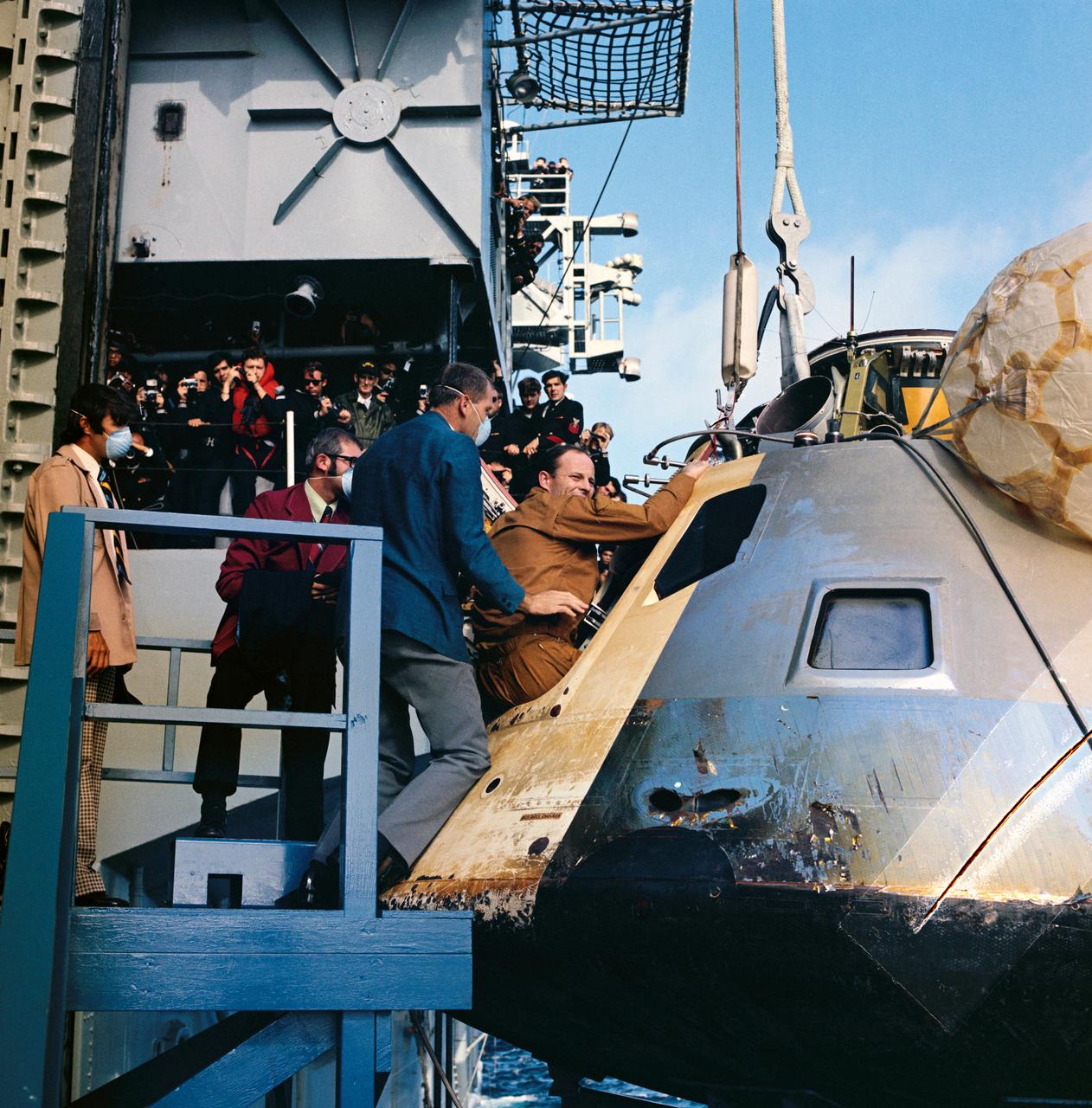 S73-36435 (25 Sept. 1973) --- Astronaut Jack R. Lousma, Skylab 3 pilot, egresses the Skylab 3 Command Module aboard the prime recovery ship, USS New Orleans, during recovery operations in the Pacific Ocean. Astronauts Lousma; Alan L. Bean, commander; and Owen L. Garriott, science pilot, had just completed a successful 59-day visit to the Skylab space station in Earth orbit. The Skylab 3 spacecraft splashed down in the Pacific about 230 miles southwest of San Diego, California.  Photo credit: NASA