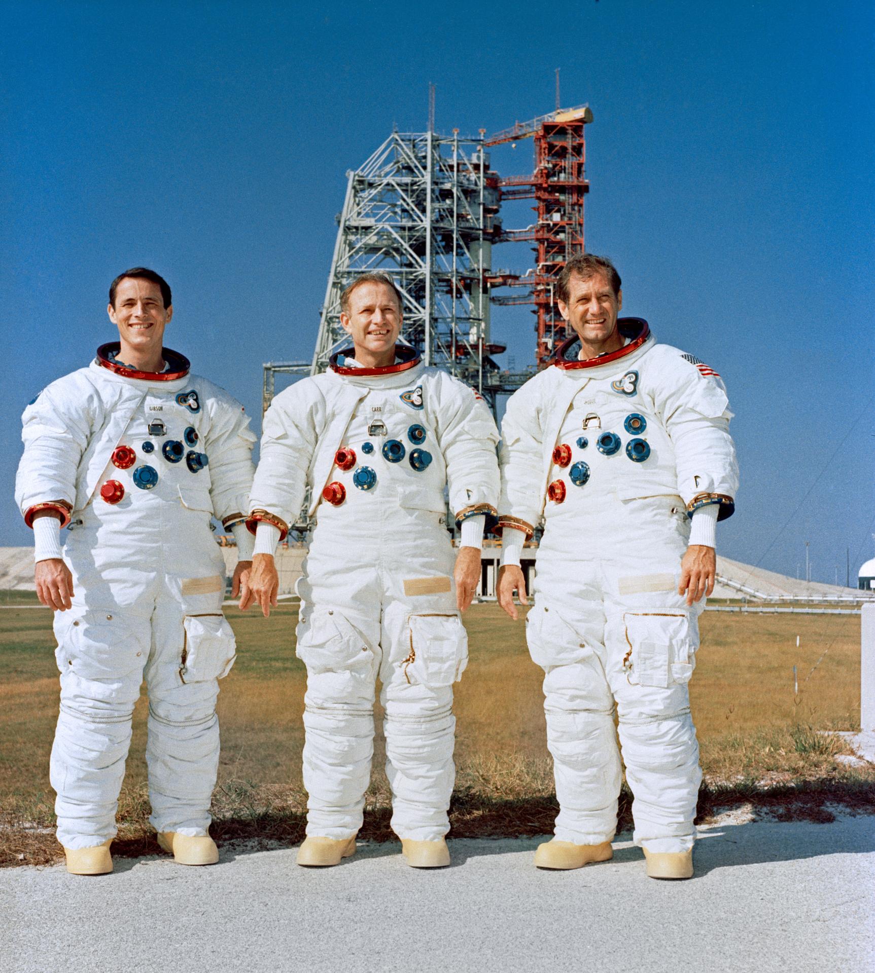 The Skylab 4 crew poses for a portrait in front of their 4/Saturn 1B space vehicle at Kennedy Space Center