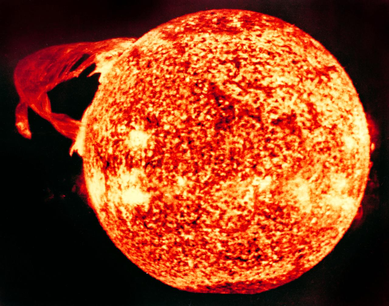 S74-23458 (19 Dec. 1973) --- This photograph of the sun, taken on Dec. 19, 1973, during the third and final manned Skylab mission (Skylab 4), shows one of the most spectacular solar flares ever recorded, spanning more than 588,000 kilometers (365,000 miles) across the solar surface. The last picture, taken some 17 hours earlier, showed this feature as a large quiescent prominence on the eastern side of the sun. The flare gives the distinct impression of a twisted sheet of gas in the process of unwinding itself. Skylab photographs such quiescent features erupt from the sun. In this photograph the solar poles are distinguished by a relative absence of supergranulation network, and a much darker tone than the central portions of the disk. Several active regions are seen on the eastern side of the disk. The photograph was taken in the light of ionized helium by the extreme ultraviolet spectroheliograph instrument of the United States Naval Research Laboratory. Photo credit: NASA