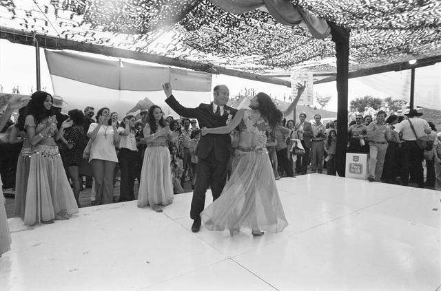 NASA image: Cosmonaut Aleksey Leonov joins belly dancer on stage at Folklife Festival