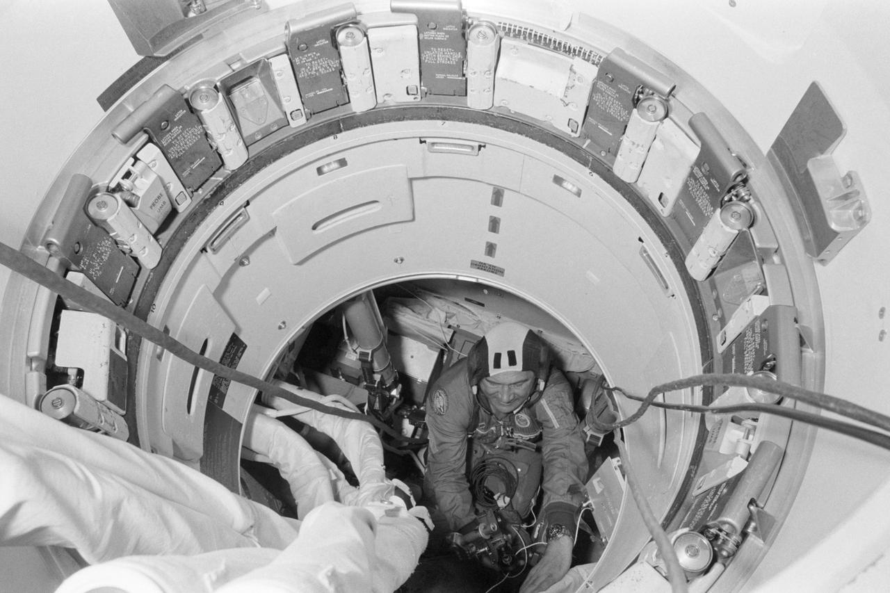 S75-21836 (20 Feb. 1975) --- Cosmonaut Anatoliy V. Filipchenko, commander of the Soviet ASTP second (backup) crew, participates in Apollo-Soyuz Test Project joint crew training in Building 35 at NASA's Johnson Space Center. Filipchenko is in the Apollo Command Module trainer. This picture was taken from inside the Docking Module during a ?walk-through? of the second day?s activities in Earth orbit.