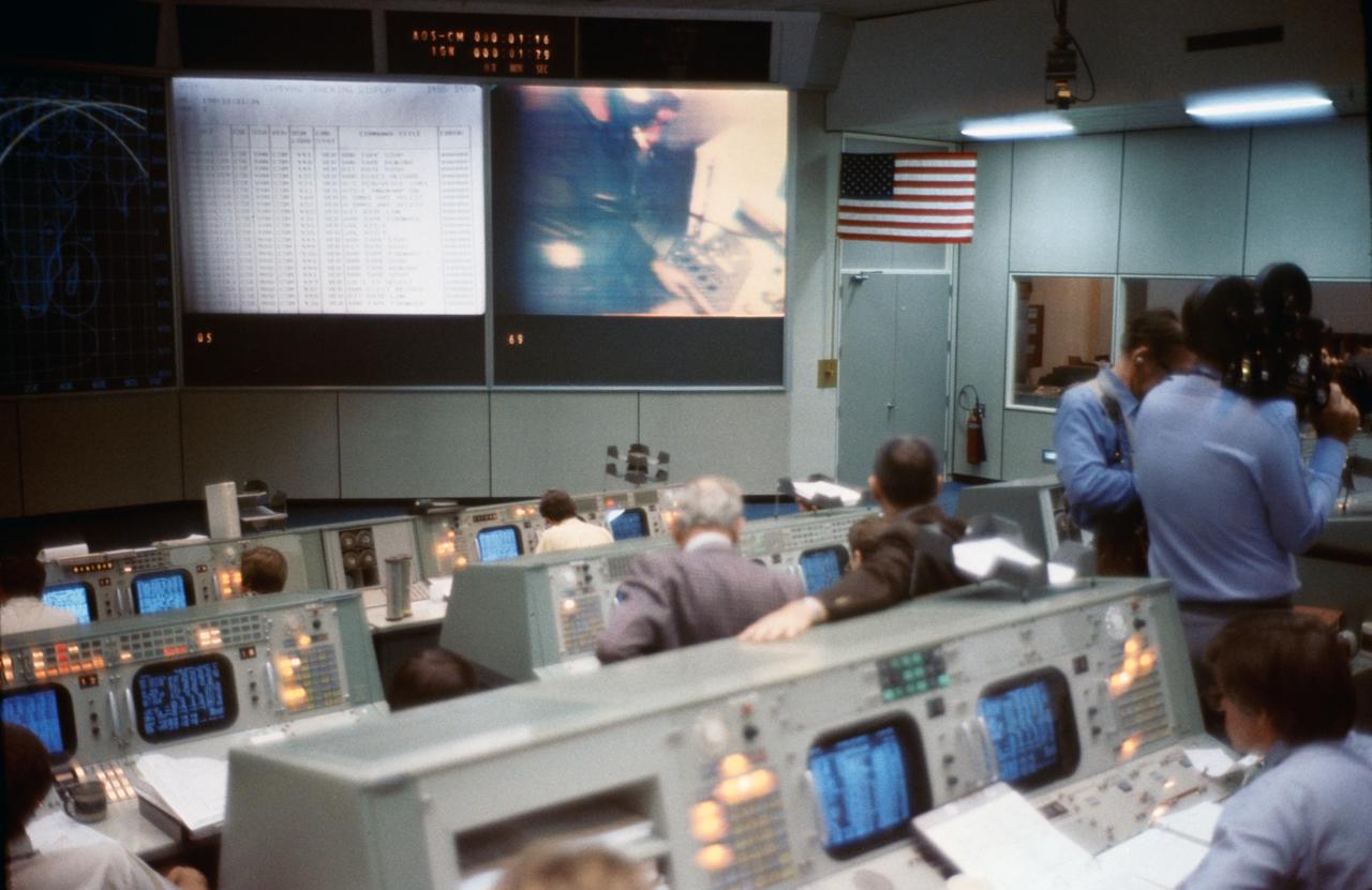 S75-23882 (20 March 1975) --- An overall view of the Mission Operations Control Room in the Mission Control Center during ASTP joint simulation activity at NASA's Johnson Space Center. M.P. Frank, the senior American ASTP flight director, is seated at his console in the lower right corner of the picture. The television monitor in the center background shows a scene from the ASTP control center in the Soviet Union. The simulations are part of the preparations for the U.S.-USSR Apollo-Soyuz Test Project docking mission in Earth orbit scheduled for July 1975.