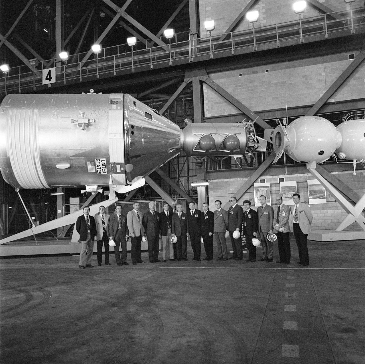 S75-24026 (4 Feb. 1975) --- A group of Soviet and American ASTP officials during a tour of the Kennedy Space Center. They were photographed next to the Apollo-Soyuz Test Project docking in Earth orbit mock-up at KSC.