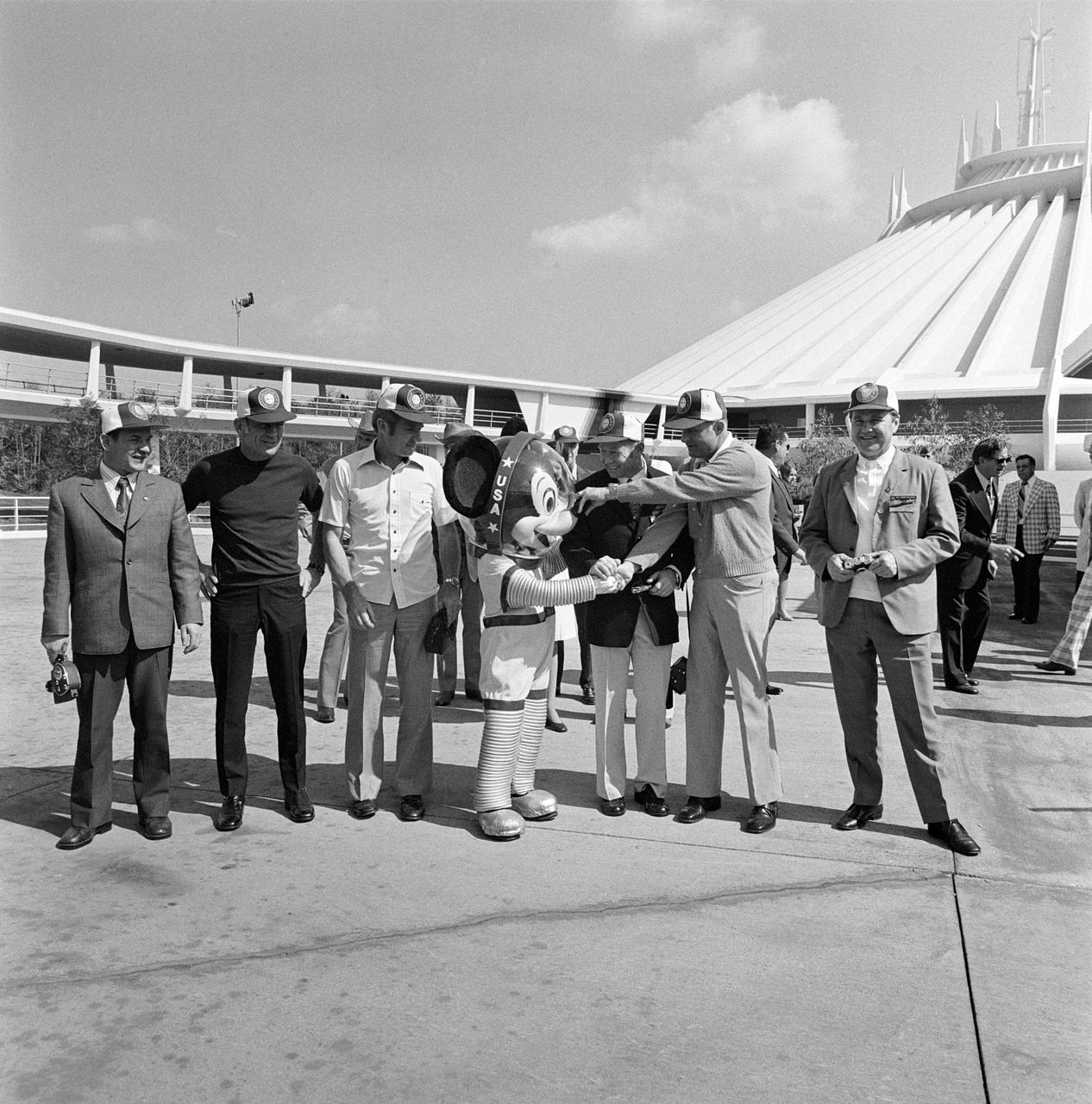 S75-24052 (8-10 Feb. 1975) --- A space-suited Mickey Mouse character welcomes the prime crewmen of the Apollo-Soyuz Test Project mission to Florida?s Disney World near Orlando. The crewmen made a side-trip to Disney World during a three-day inspection tour of NASA's Kennedy Space Center. The crewmen were at KSC to look over launch facilities and flight hardware. Receiving the jovial Disney World welcome are, left to right, cosmonaut Valeriy N. Kubasov, engineer on the Soviet crew; astronaut Donald K. Slayton, docking module pilot of the American crew; astronaut Vance D. Brand, command module pilot of the American crew; cosmonaut Aleksey A. Leonov, commander of the Soviet crew; astronaut Thomas P. Stafford, commander of the American crew; and cosmonaut Vladimir A. Shatalov, Chief of Cosmonaut Training for the USSR.