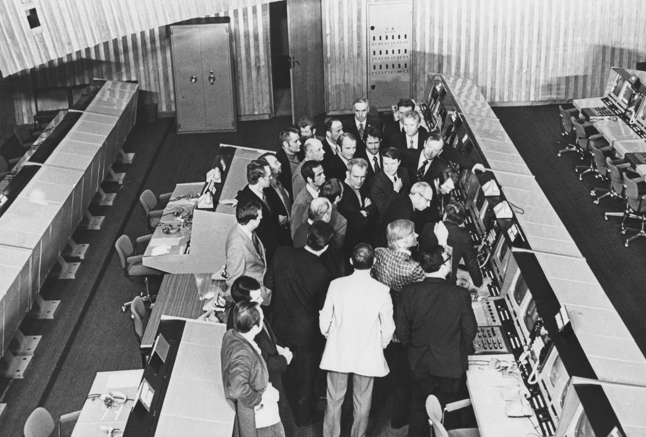 S75-25619 (25 April 1975) --- A group of American ASTP crewmen is briefed on the operation of the consoles in the main control room at the ASTP flight control center at the Cosmonaut Training Center (Star City) near Moscow. The astronauts were in the Soviet Union for ASTP joint crew training with the Soviet ASTP crewmen. PHOTO COURTESY: USSR ACADEMY OF SCIENCES