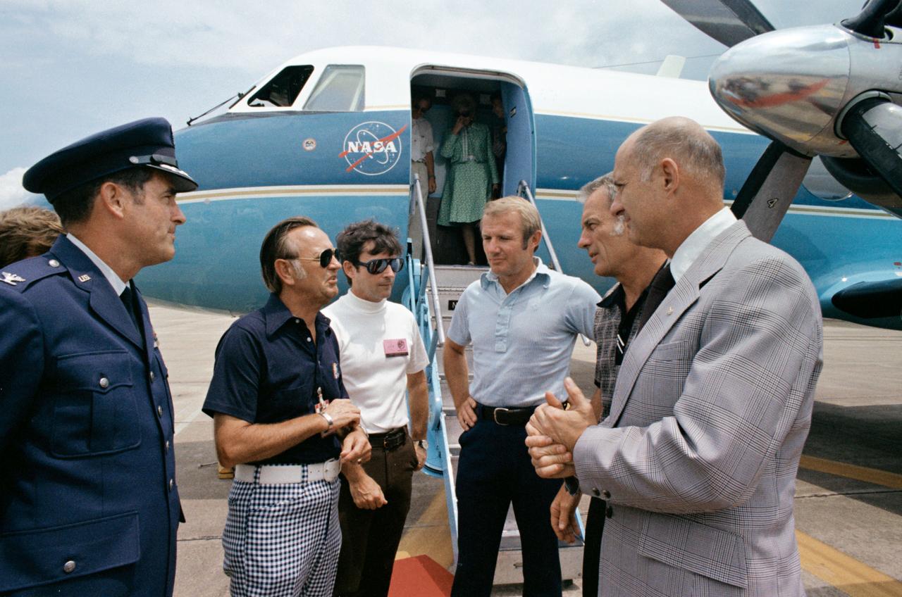 S75-30109 (10 Aug. 1975) --- Dr. Christopher C. Kraft Jr. (second from left), JSC Director, chats with the three ASTP crewmen on the runway at Ellington Air Force Base after their arrival home from the Pacific recovery area.  The six men are, left to right, Col. Donald Robinson, EAFB commander; Dr. Kraft; astronaut John W. Young, Chief of the Astronaut Office at JSC; astronaut Vance D. Brand, command module pilot of the crew; astronaut Donald K. Slayton, docking module pilot of the crew; and astronaut Thomas P. Stafford, crew commander.  This picture was taken prior to the official welcoming ceremonies. The crewmen?s wives are still aboard the plane. Medical treatment in Hawaii delayed the return of the crew to JSC.  They suffered a pulmonary irritation from inhalation of a toxic gas minutes before splashdown on July 24, 1975.