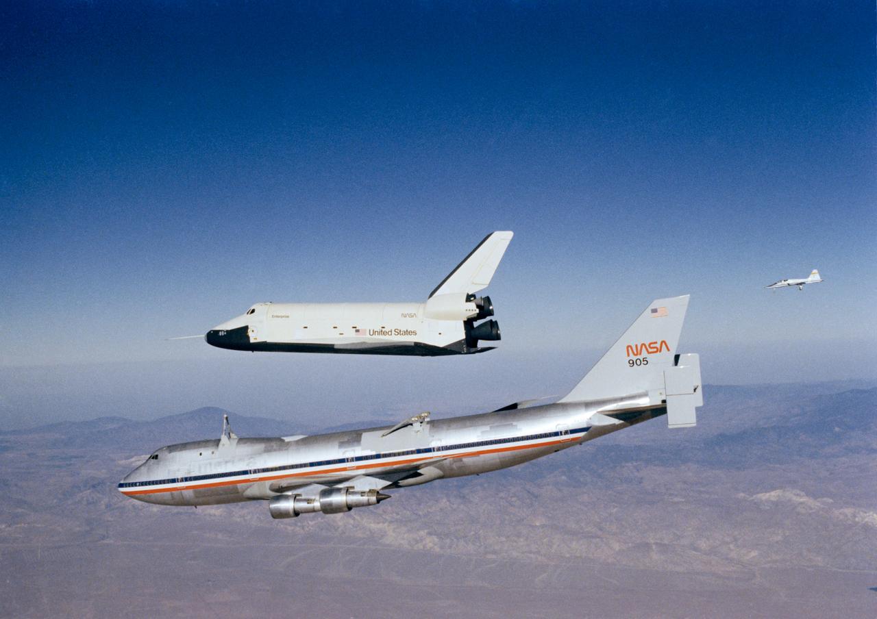 S77-28931 (12 Oct. 1977) --- The Orbiter 101 "Enterprise" separates from the NASA 747 carrier aircraft to begin its first "tailcone-off" unpowered flight over desert and mountains of Southern California. A T-38 chase plane follows in right background. This was the fourth in a series of five piloted free flights. Photo credit: NASA