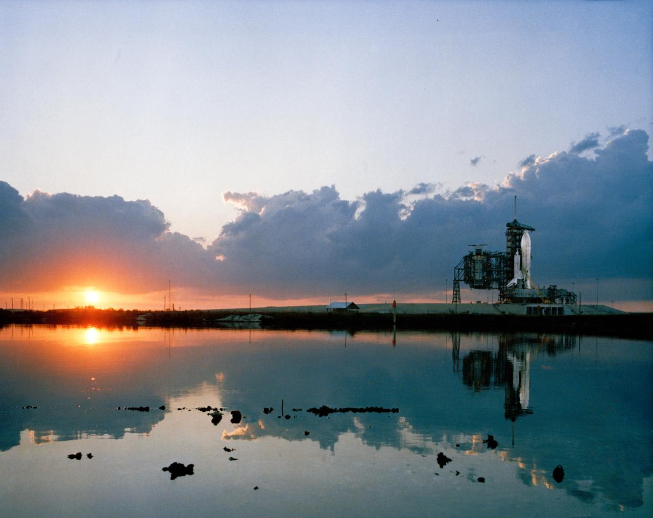 S81-28974 (March 1981) --- An early morning scene at the Kennedy Space Center's Launch Complex 39, with the space shuttle Columbia in position on Pad A at right. Launch for the STS-1 mission is set for April 10th with astronauts John W. Young and Robert L. Crippen aboard. Photo credit: NASA