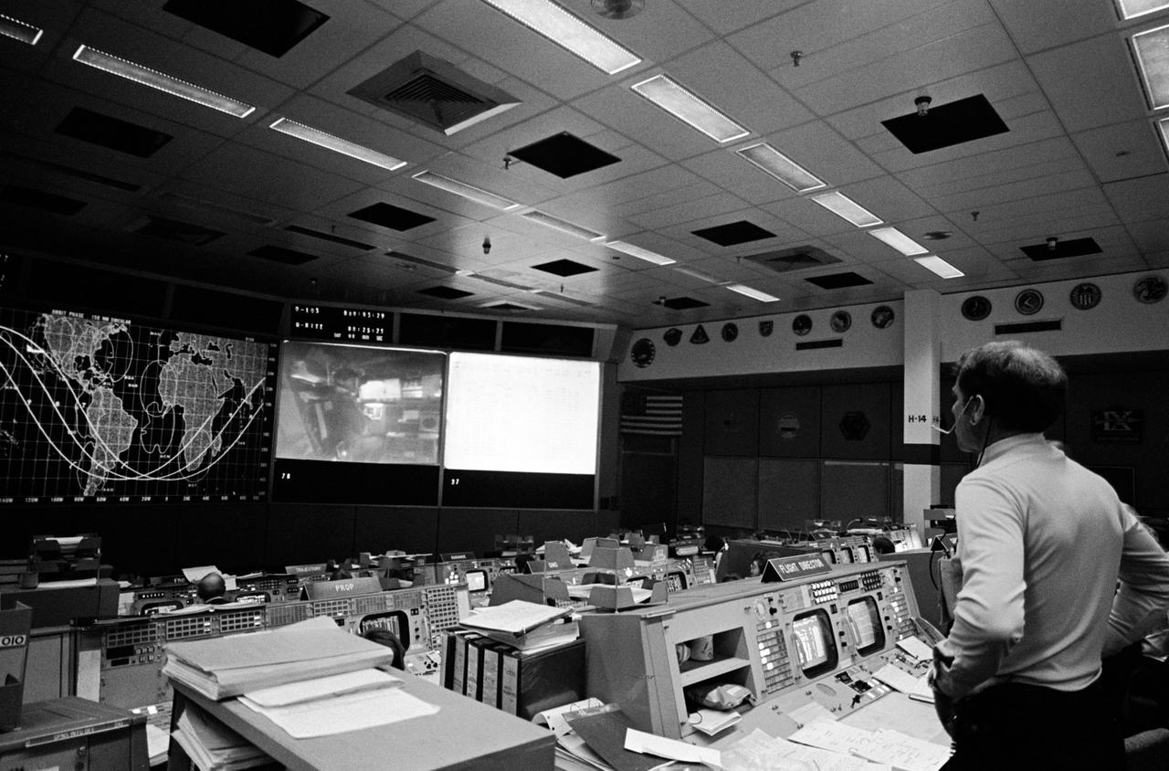 S81-30216 (12 April 1981) --- Astronaut Joe H. Engle, backup crew commander for STS-1, watches a large screen in the mission operations control room of the Johnson Space Center?s Mission Control Center during the STS-1 flight?s prime crew commander?s status report. Astronaut John W. Young, commander, can be seen in the image at left center, which is displayed via rear screen projector. Photo credit: NASA