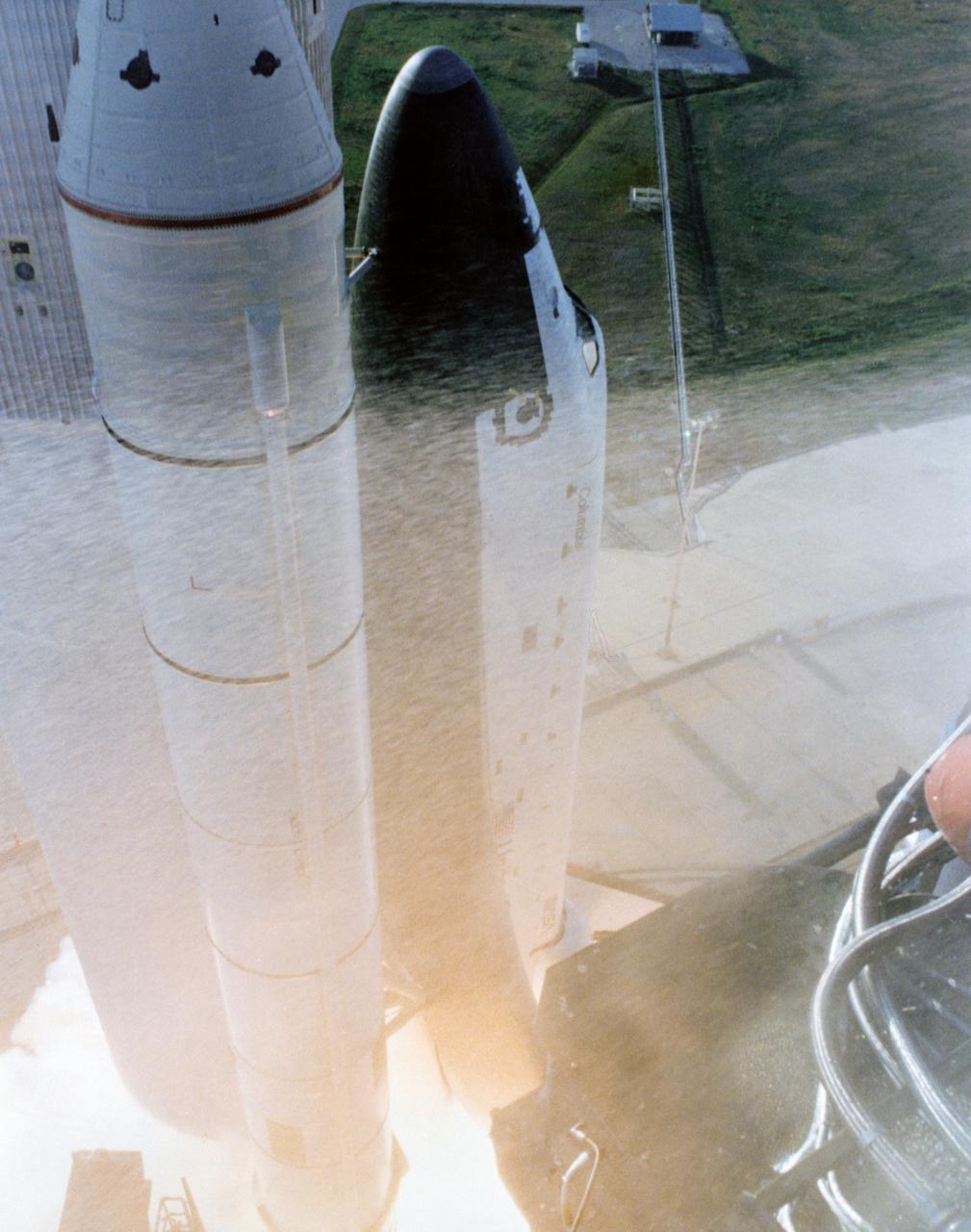 S81-30501 (12 April 1981) --- Nose pointed skyward, space shuttle Columbia begins its climb toward orbit moments after solid rocket booster ignition in this first view of a dramatic liftoff sequence photographed from the 275-feet level of the Fixed Service Structure on Pad 39A. The seven frame sequence documenting the space shuttle’s historic launch on its maiden voyage was taken with a Nikon camera equipped with a 28mm lens with a 250 exposure back. The camera was protected in a fire box. Photo credit: NASA