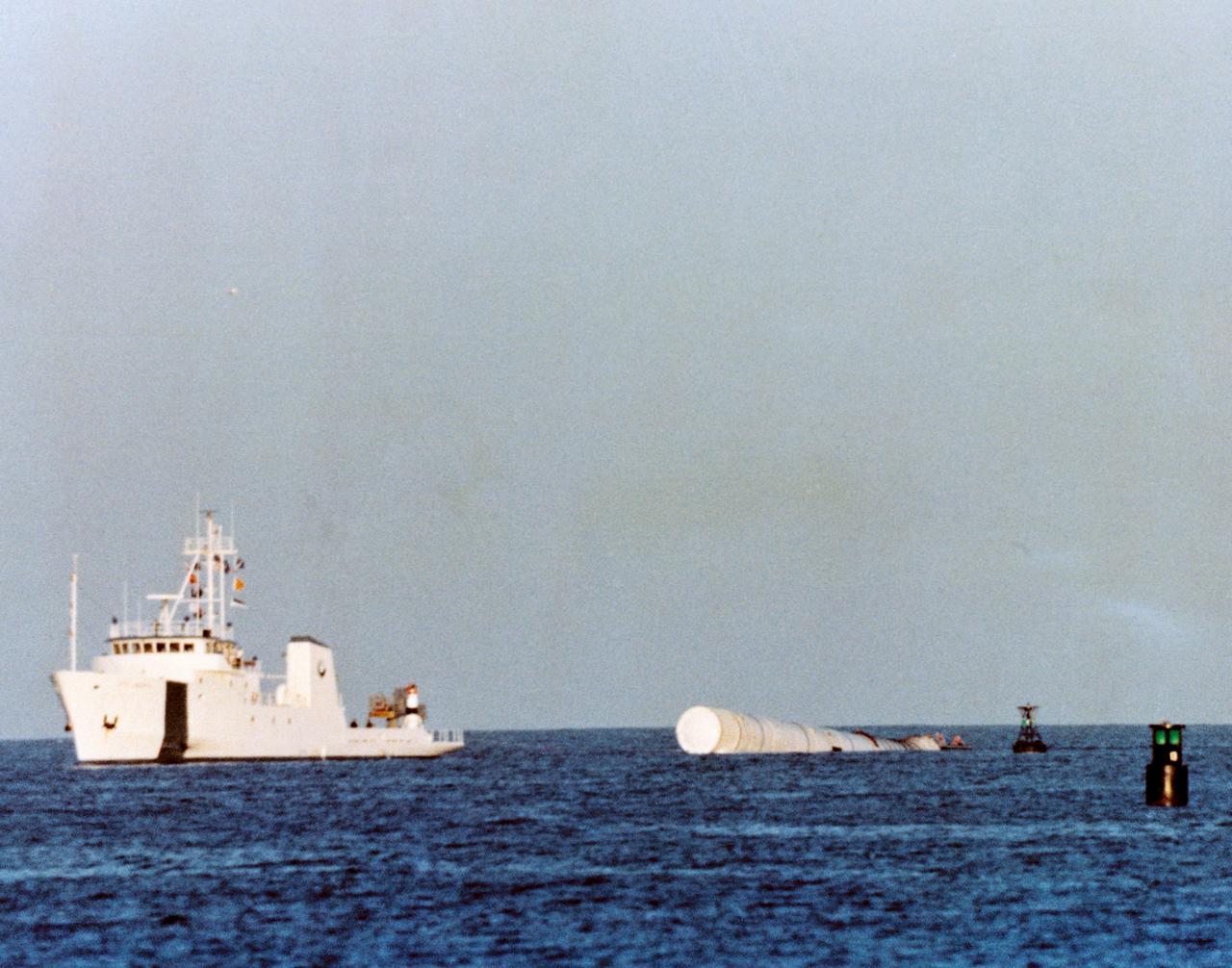 S81-30953 (13 April 1981) --- With one of the two expended solid rocket boosters from the launch of the space shuttle Columbia in tow, the recovery ship UTC Liberty heads toward the Trident Submarine Basin at Port Canaveral, south of NASA's Kennedy Space Center (KSC). The ship, built especially for the task of recovering expended boosters and their parachutes, is bound for ran overnight berth in the submarine basin, before continuing tomorrow toward recovery facilities at KSC. Photo credit: NASA
