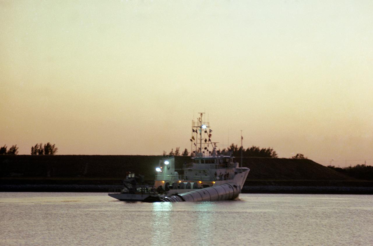 S81-31308 (13 April 1981) --- The solid rocket booster recovery ship UTC Liberty heads for Cape Canaveral Air Force Station after retrieving one of the two booster casings from the launch of Columbia, America?s first space shuttle in orbit. The vessel had been tied up overnight at the Trident Submarine Basin at Port Canaveral, from which point this photograph was made. The boosters and the parachutes that bring them to safe landings in the Atlantic east of NASA's Kennedy Space Center are recovered at sea, dewatered and towed to processing facilities at Cape Canaveral Air Force Station. Photo credit: NASA