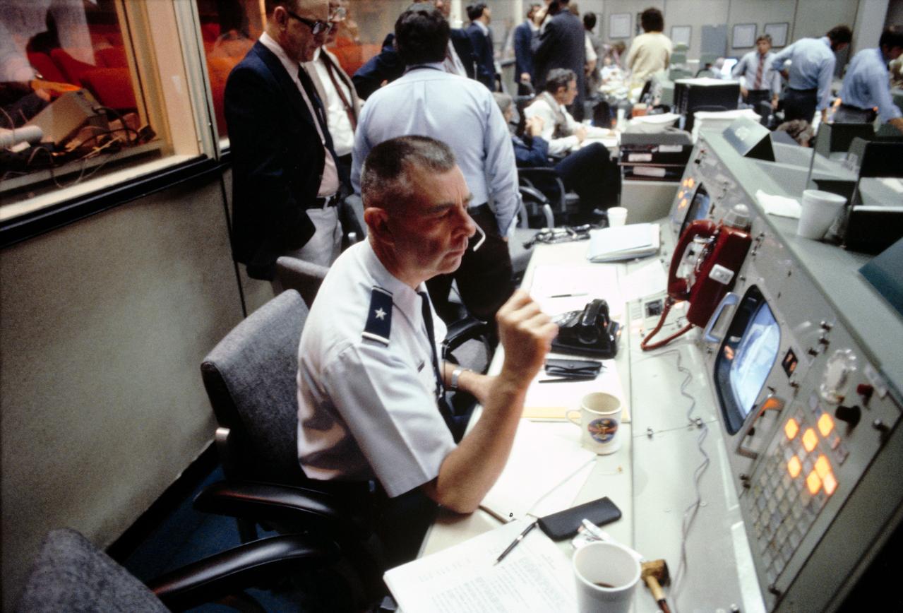 S81-32876 (13 April 1981) --- Brig. Gen. William T. Twinting studies the monitor at the Department of Defense (DOD) console in the mission operations control room (MOCR) at the Johnson Space Center?s Mission Control Center (MCC). He is deputy DOD manager for Space Shuttle Support Operations. Gen. Twinting and the other flight controllers seen in the background listen as astronaut John W. Young, STS-1 commander, describes the scenery of a downlink TV transmission. Photo credit: NASA