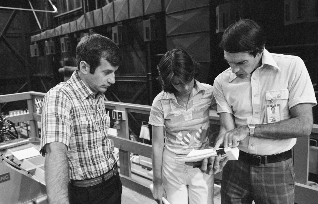 Astronauts Sally Ride and Terry Hart prepare for remote manipulator system (RMS) training for STS-2 in bldg 9A. Views include Ride, Hart and Robert R. Kain of the Flight Activites Branch reviewing procedures for RMS training (34262); Ride and Hart stand beside the RMS control center looking down at the payload bay mock-up (34263).