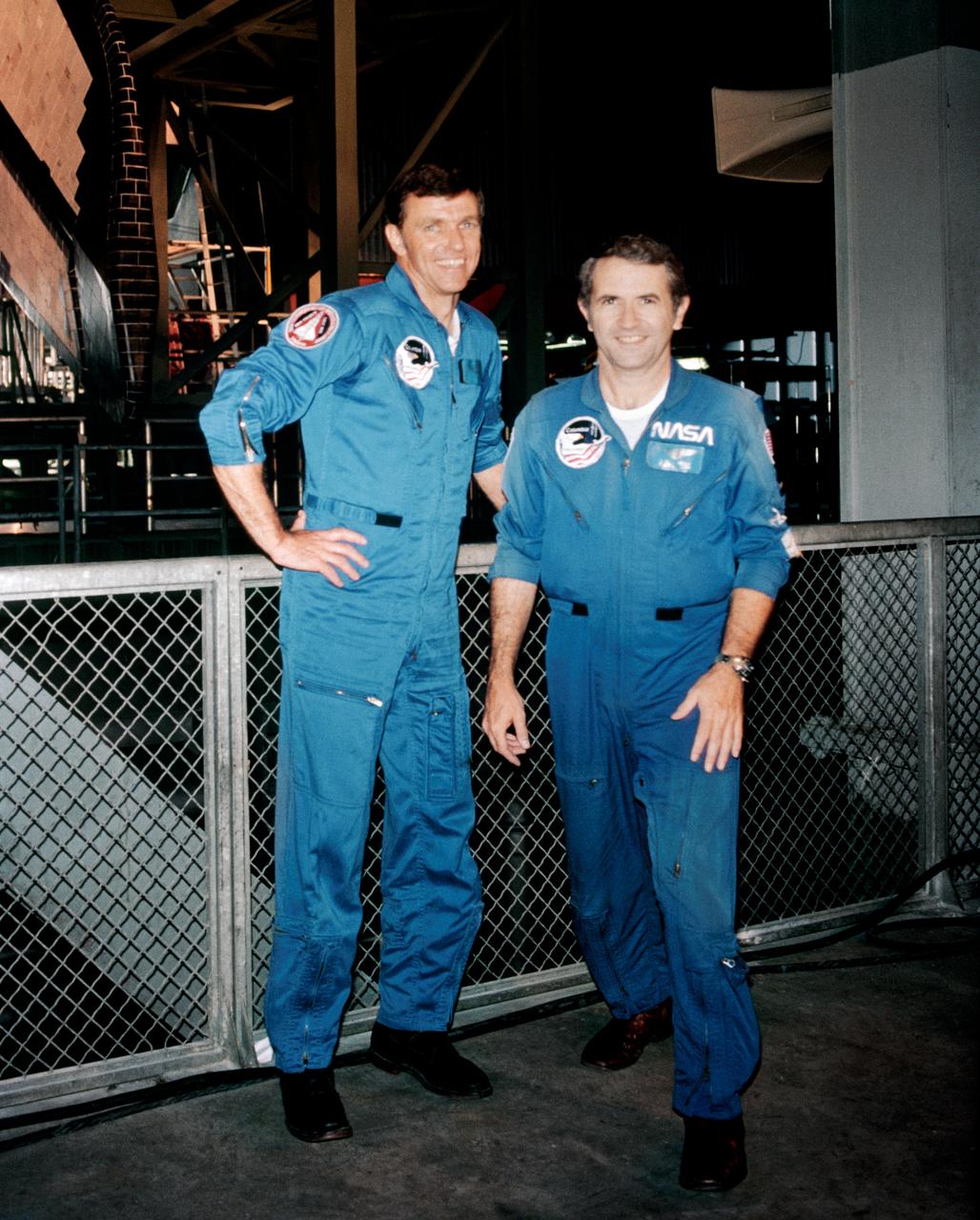 S81-36331 (24 Aug. 1981) --- Astronauts Joe H. Engle, left, and Richard H. Truly pause before participating in the integrated test of the assembled space shuttle components scheduled for launch no earlier than Sept. 30, 1981. Moments later, Engle, STS-2 crew commander, and Truly, pilot, entered the cabin of the orbiter Columbia for a mission simulation. The shuttle integrated tests (SIT) are designed to check out every connection and signal path in the STS-2 vehicle composed of the orbiter, two solid rocket boosters (SRB) and an external fuel tank (ET) for Columbia?s main engines. Completion of the tests will clear the way for preparations for rollout to Pad A at Launch Complex 39, scheduled for the latter part of August or early September. Photo credit: NASA