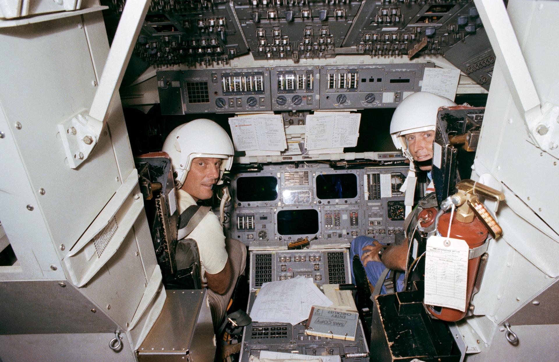 Jack Lousma and Gordon Fullerton inside the space shuttle simulator