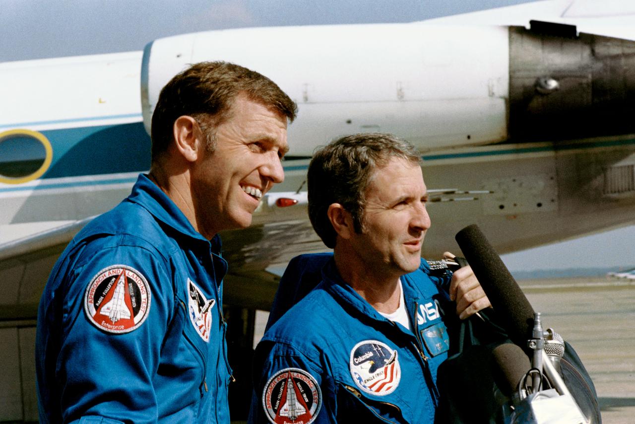 S81-39413 (5 Nov. 1981) --- Astronauts Joe H. Engle, left, and Richard H. Truly greet newsmen upon their return to Ellington Air Force Base near NASA's Johnson Space Center (JSC), from Kennedy Space Center (KSC) after learning their flight (STS-2) has been postponed a week. The launch of NASA?s second space shuttle mission, in the Columbia, has been rescheduled for Nov. 12, 1981. Photo credit: NASA