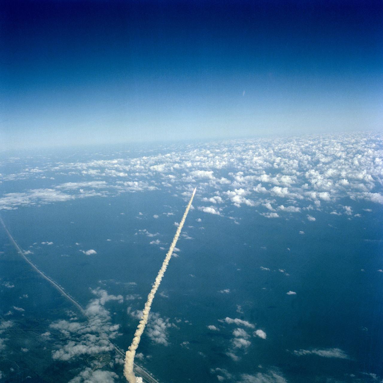 S81-39440 (12 Nov. 1981) --- The tiny image of the space shuttle Columbia, its two solid rocket boosters and an external fuel tank feeding Columbia?s engines was captured on camera by one who can truly relate to the thoughts of the astronauts aboard ? John W. Young who was aboard the same spacecraft for its successful debut in April of this year. Young was flying NASA?s shuttle training aircraft (STA) when he used a hand-held camera to record this scene on 70mm film. Astronauts Joe H. Engle, STS-2 commander, and Richard H. Truly, pilot, were aboard Columbia. Photo credit: NASA