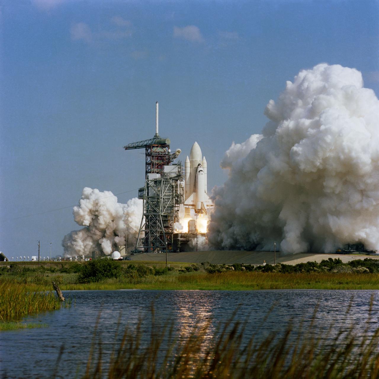 S81-39548 (12 Nov. 1981) --- NASA's space shuttle Columbia climbs toward space for a return visit after its 10:10 a.m. liftoff from Launch Pad 39A. Aboard the space shuttle, astronauts Joe H. Engle and Richard H. Truly man the flight deck. On its second mission (STS-2), Columbia carries a payload of science and applications experiments and an arm-like robot device named a remote manipulator system (RMS). Photo credit: NASA