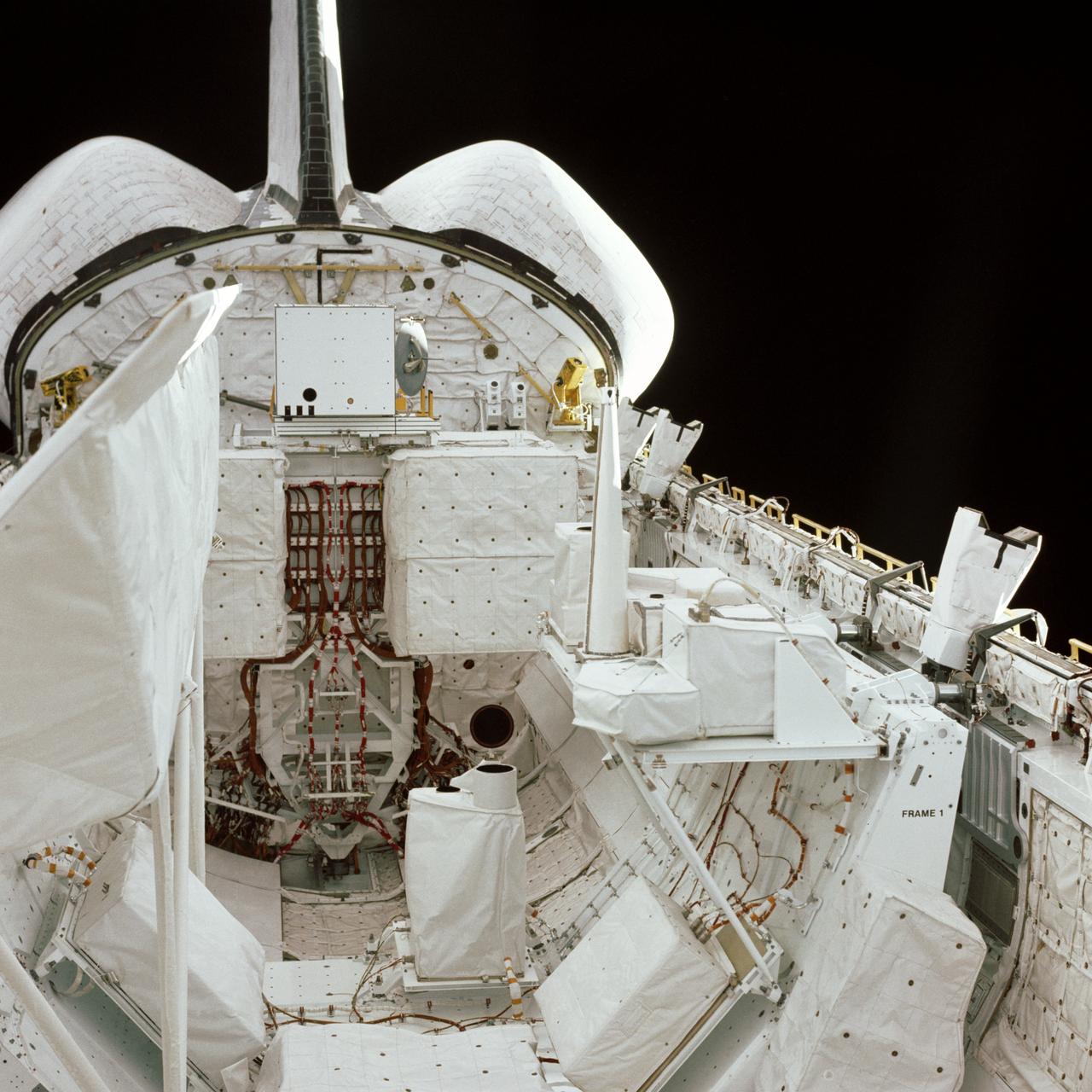 S81-39556 (13 Nov. 1981) --- This photograph of the cargo bay of NASA?s space shuttle Columbia was taken by the STS-2 crewmen from inside the shuttle?s cabin. In the foreground is the pallet of experiments developed by NASA?s Office of Space and Terrestrial Applications (OSTA). The orbital maneuvering system (OMS) pods and vertical stabilizer of Columbia are in upper left corner. The window through which this 70mm frame was exposed is one of two on the aft side of the flight deck. Astronauts Joe H. Engle, commander, and Richard H. Truly, pilot, were aboard the Columbia on its second trip for two days, six hours, 13 minutes and 10 seconds prior to landing at Edwards Air Force Base. Photo credit: NASA