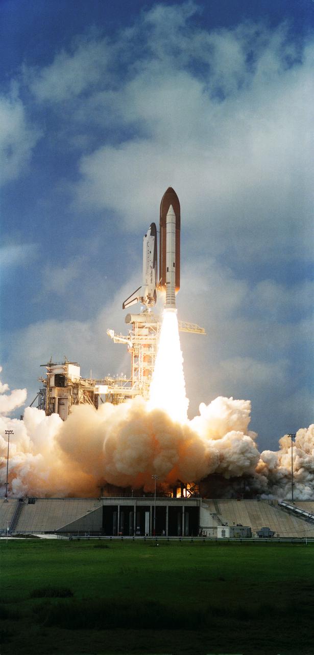 S82-28746 (22 March 1982) --- The space shuttle Columbia, with its third crew aboard, two solid rocket boosters (SRB) and external fuel tank (ET) are photographed as they clear the launch pad at Kennedy Space Center?s Launch Complex 39. Astronauts Jack R. Lousma, STS-3 commander, and C. Gordon Fullerton, pilot, were in Earth orbit some ten minutes later looking ahead to seven days of work in space. The external tank is unpainted for the first time, appearing a dark orange in the color photos and dark gray in black and white. Photo credit: NASA