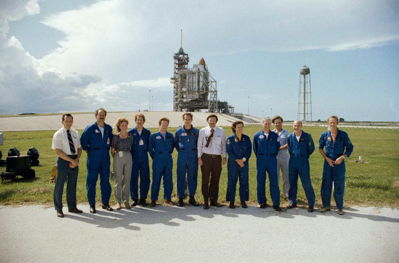 S82-32201 (29 May 1982) --- Members of the JSC astronaut corps, vehicle integration test team (VITT) and other personnel pose for a photograph at the completion of a countdown demonstration test (CDDT) at Launch Pad 39A, Kennedy Space Center (KSC). The participants are, from the left, Wilbur J. Etbauer, engineer with the VITT; mission specialist-astronaut James D. Van Hoften; Terri Stanford, engineer from JSC's flight operations directorate; mission specialist-astronaut Steven A. Hawley; astronaut Richard N. Richards; astronaut Michael J. Smith; Richard W. Nygren, head of the VITT; mission specialist-astronaut Kathryn D. Sullivan; astronaut Henry W. Hartsfield Jr., STS-4 pilot; Mark Haynes, a co-op student participating with the VITT; astronaut Thomas K. Mattingly II, STS-4 commander; and astronaut Donald E. Williams. Photo credit: NASA