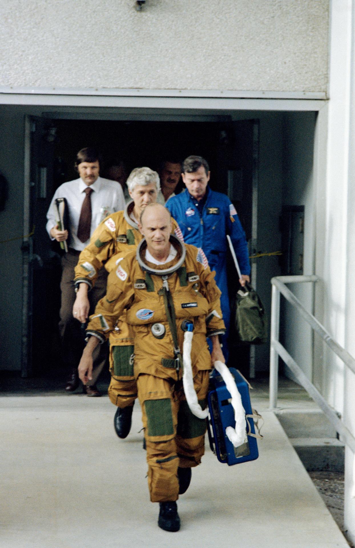 The STS-4 crew walks out to the transfer van on launch day