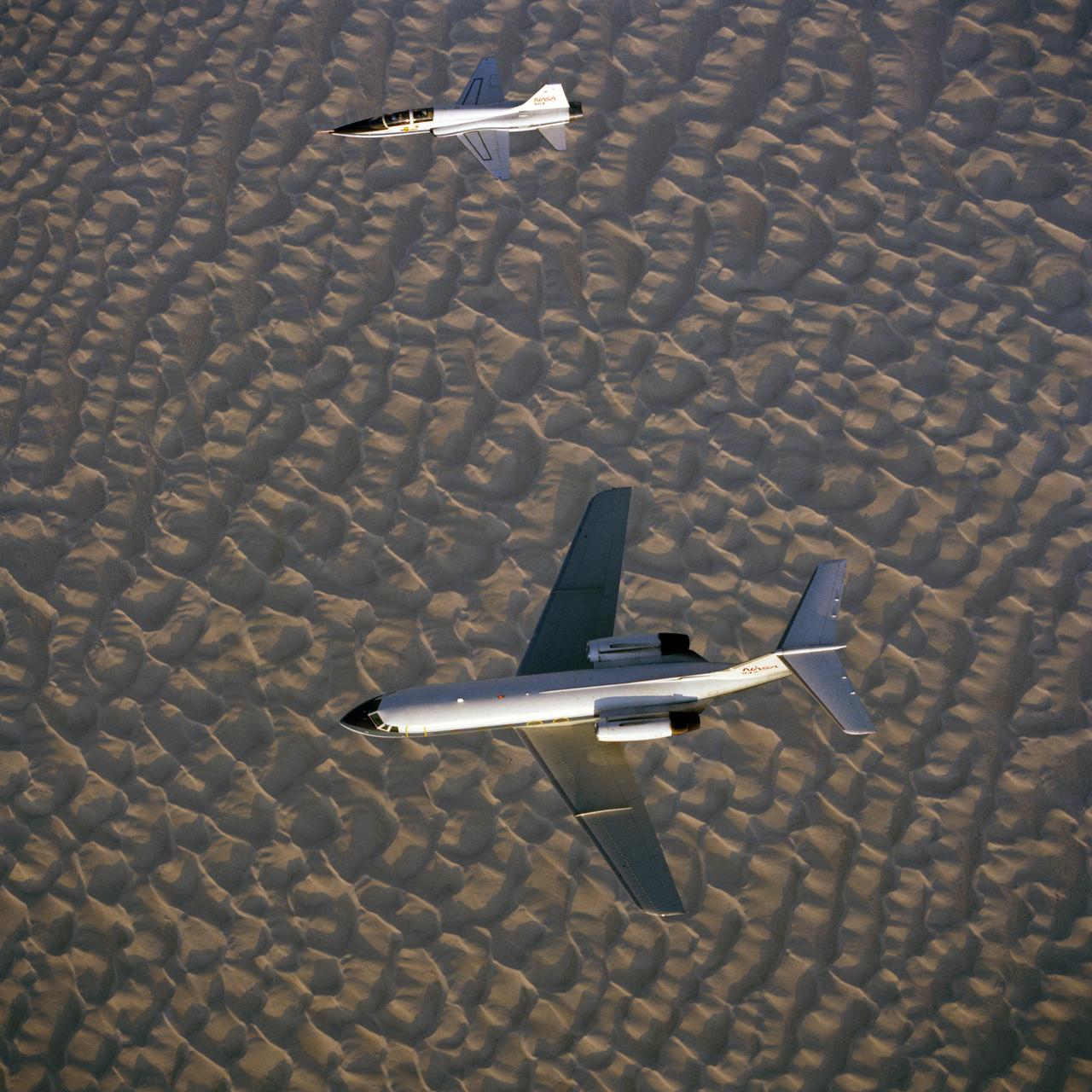 S82-32204 (October 1982) --- NASA 947 and NASA 904, two aircraft stationed at Ellington Air Base for the Johnson Space Center (JSC), are captured during a training and familiarization flight over White Sands, New Mexico. The Gulfstream aircraft (bottom) is NASA?s Space Shuttle Training Aircraft (STA) and the T-38 jet serves as a chase plane. Photo credit: NASA