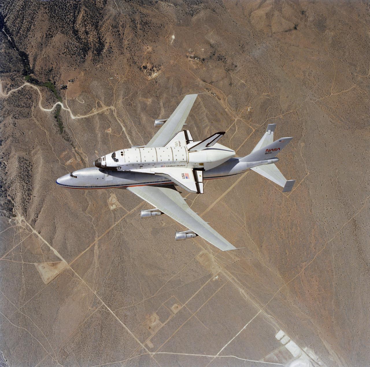 S82-33421 (4 July 1982) --- This spectacular view of the NASA 905 transport aircraft taxiing the new space shuttle Challenger was recorded from a T-38 aircraft as the aircraft were heading for Houston, Texas and a combination "meet the Challenger and greet the STS-4 crew" ceremony at Ellington Air Force Base. The STS-4 astronauts-Thomas K. Mattingly II, and Henry W. Hartsfield Jr., were minutes ahead of the tandem in another aircraft. Earlier today they completed a successful week-long stay in space aboard the Columbia. Upon their landing at Edwards Air Force Base, a historical "first" occurred for NASA and this nation. Three shuttlecraft ? The Enterprise, Challenger and Columbia ? were together at one time in the same location. The hardware served as a backdrop for a speech by President Ronald Reagan leading the nation in a special July 4 celebration. Following the stopover in Houston, the Challenger will move onto Florida for processing in preparation for future spaceflights. Photo credit: NASA